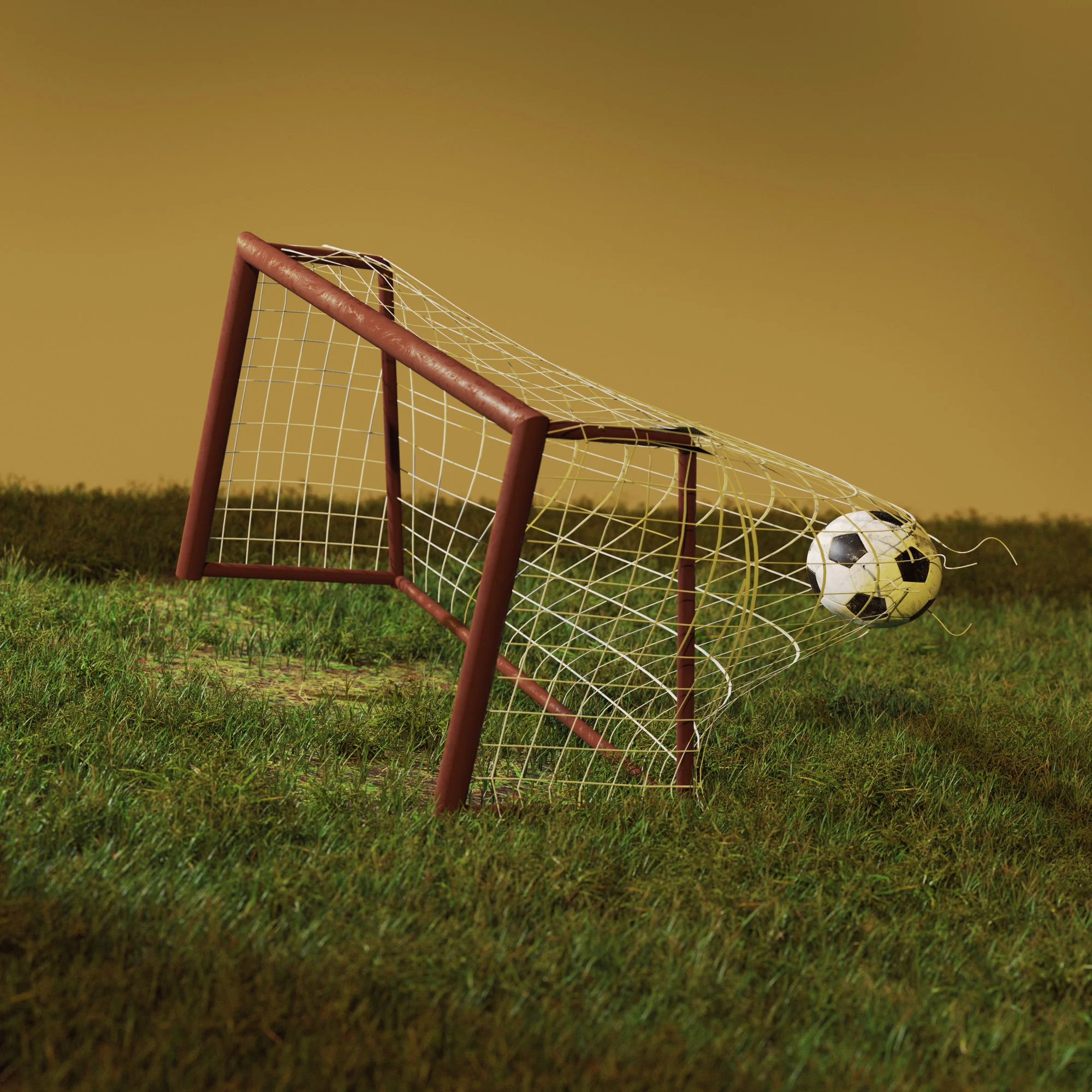 A football or soccer ball bursting through a mini goal net on a worn down soccer or football field.