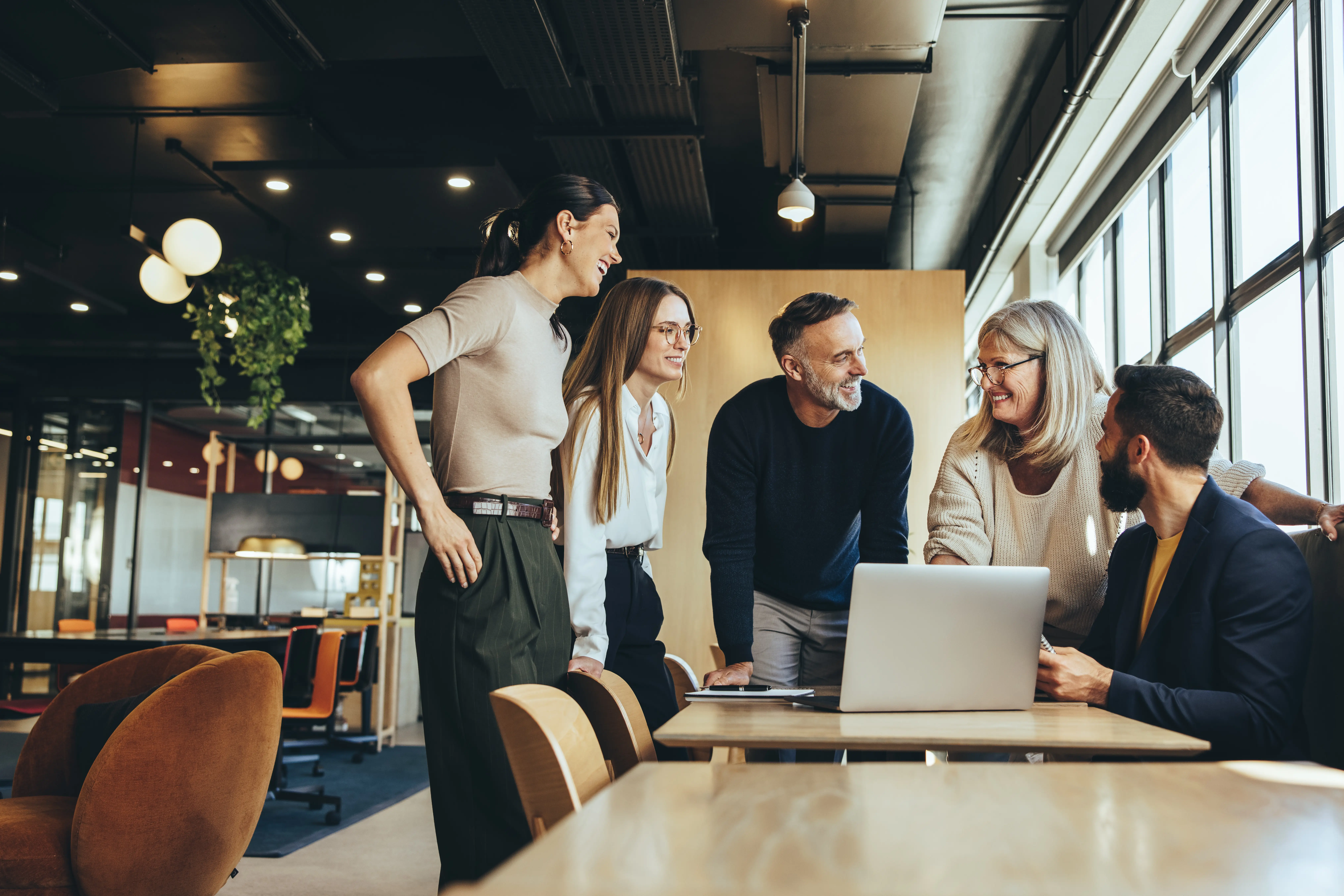 Team of professionals collaborating in a modern office, emphasizing the importance of teamwork in Case Study Two by Alberts & Gabriel.