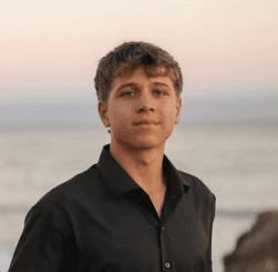 Black and white portrait of a man with a beard and glasses