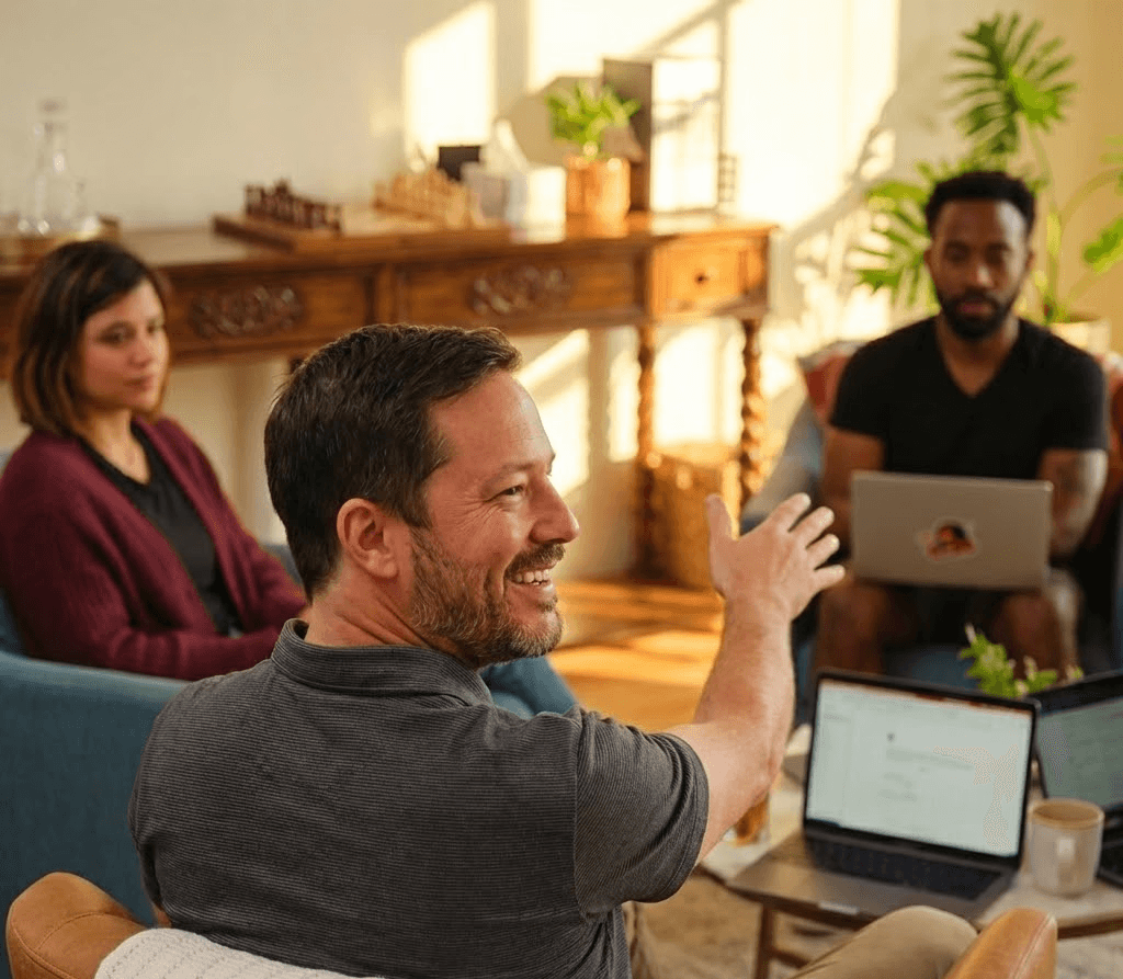 Close-up of a scientist holding a tray of petri dishes with purple cultures, wearing gloves and safety gear.