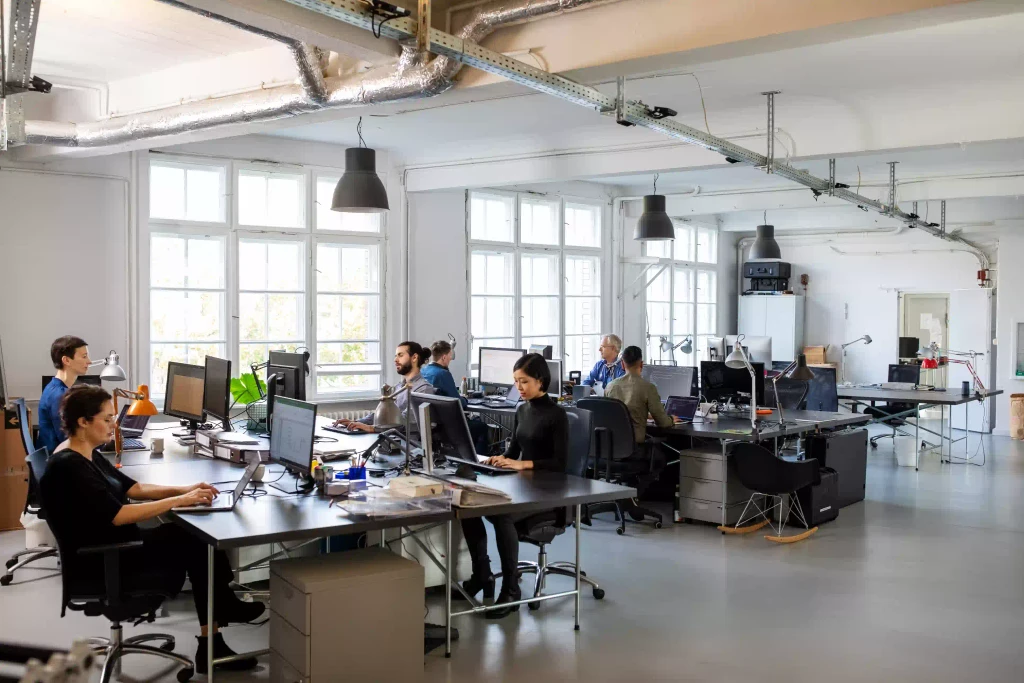 Modern open office space with desks and collaborative areas, symbolizing the importance of face-to-face collaboration and creativity.