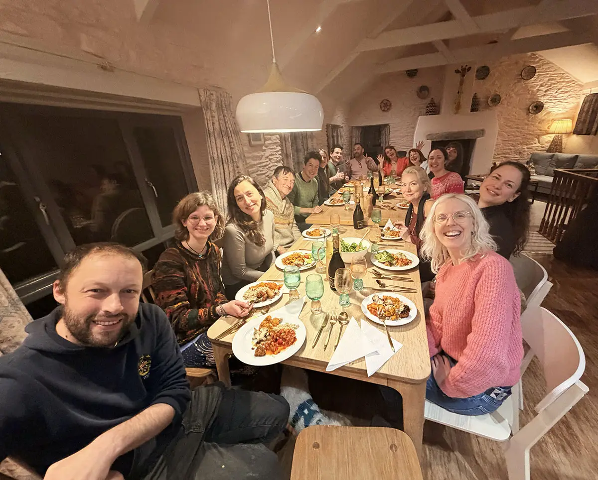 Froomies residents sharing a communal dinner together in the farmhouse kitchen