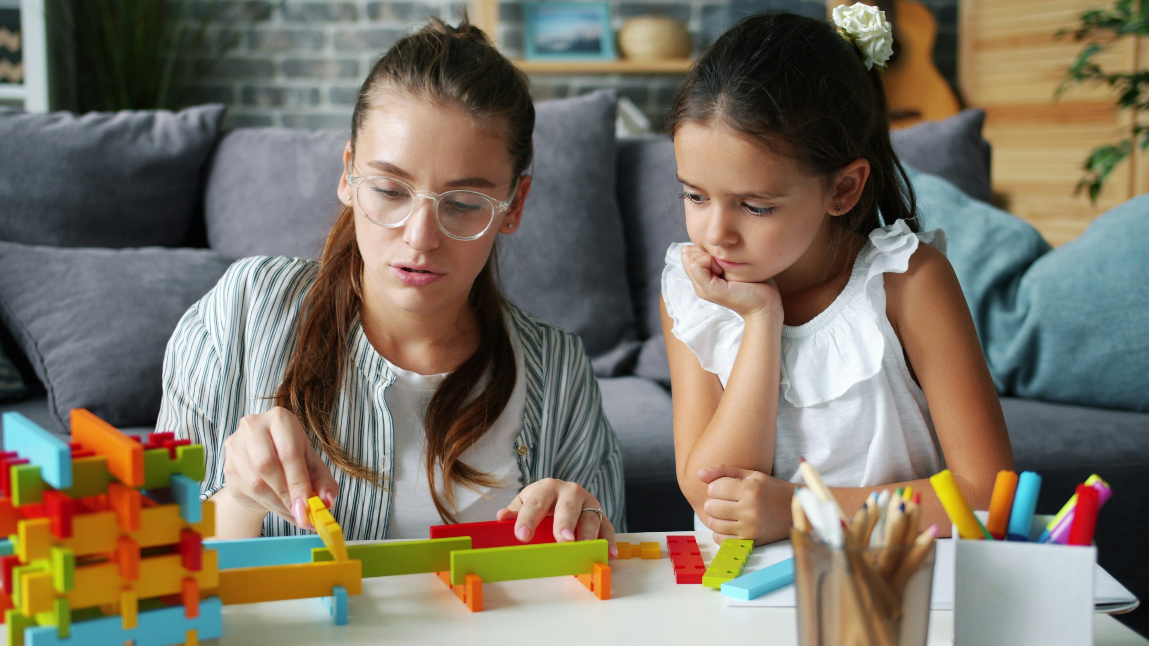 Woman and child building with colorful blocks
