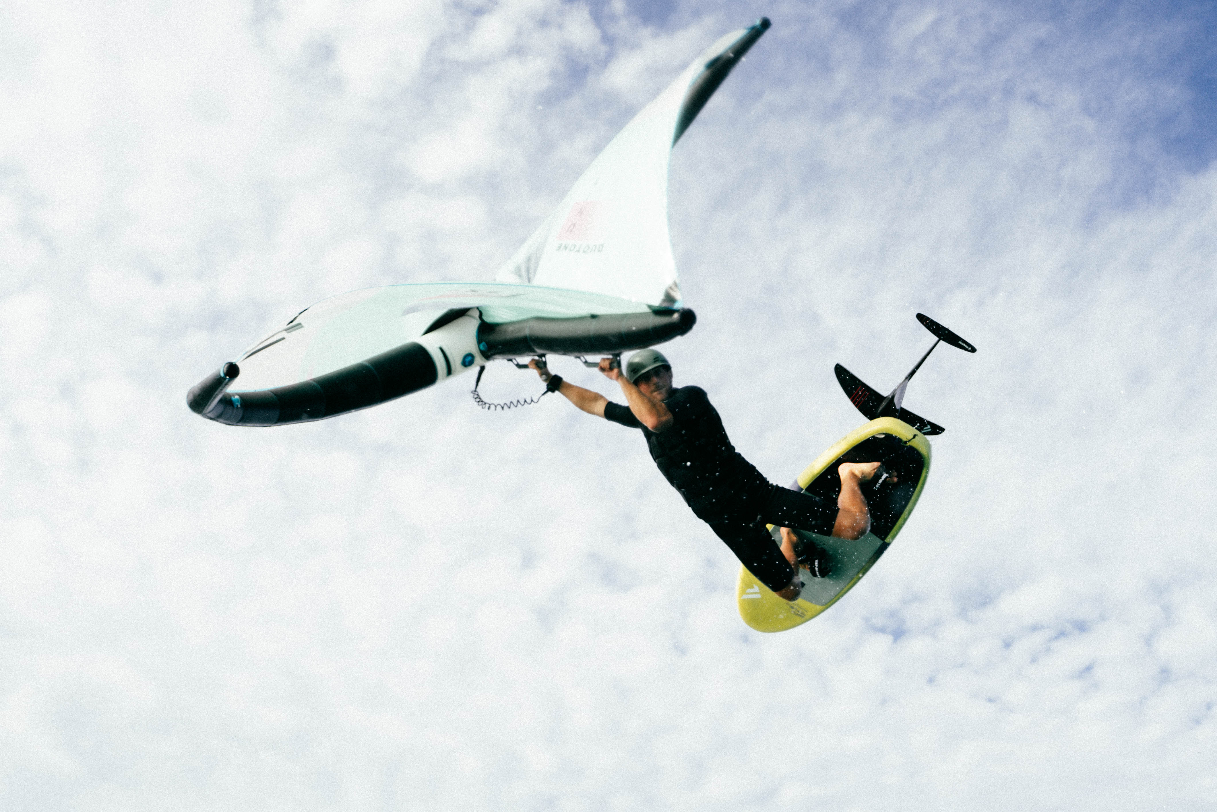 wing foiler jumping over camera