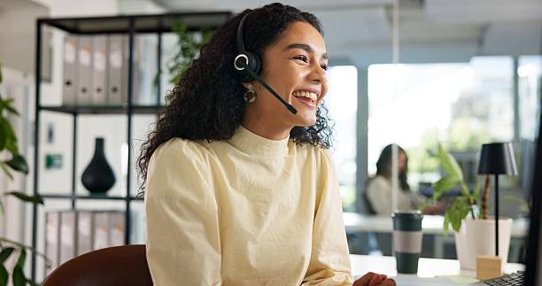 image of a woman wearing aheadset smiling in an office
