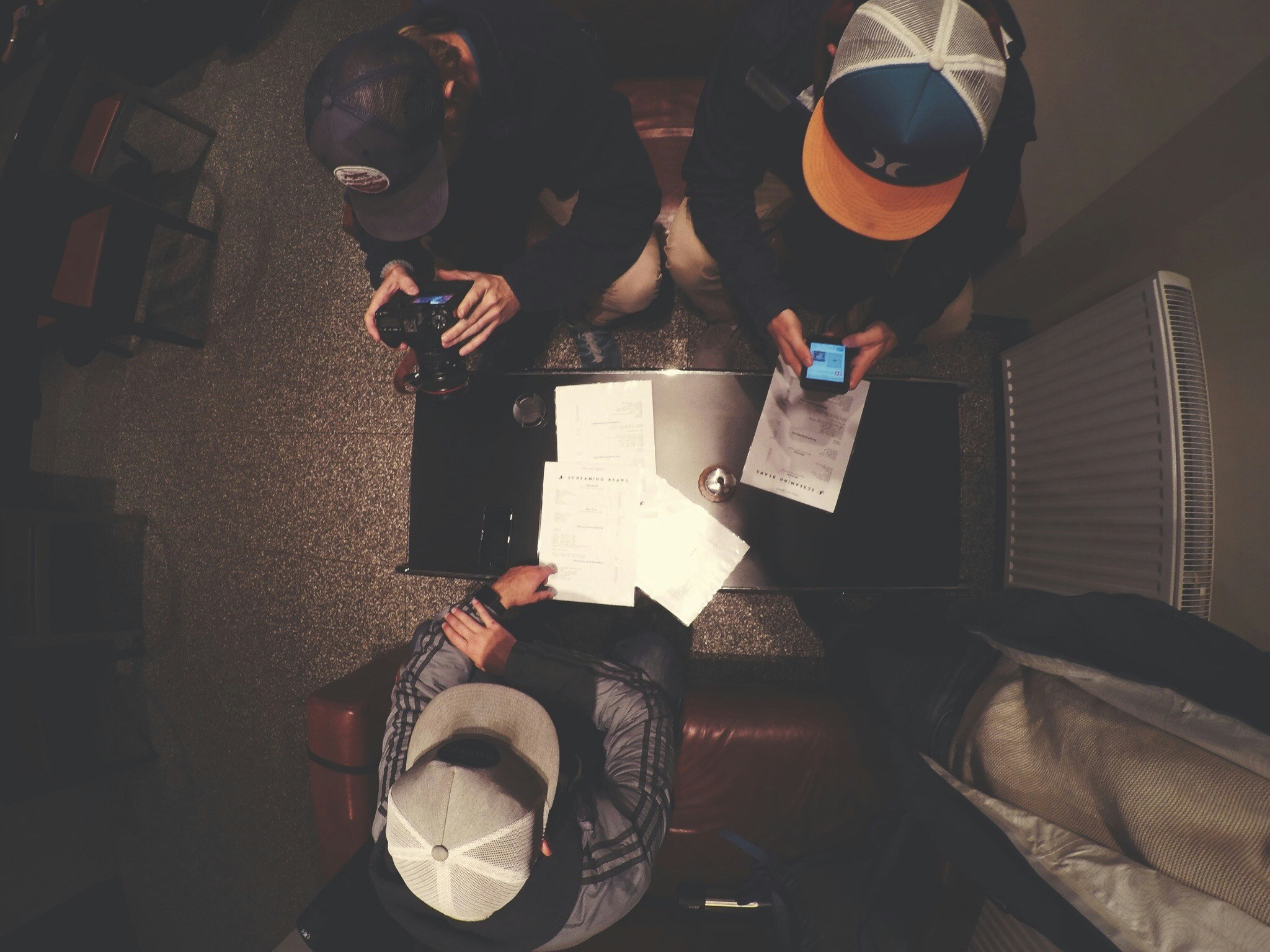 Overhead shot of people collaborating over documents together. Photo by Jeremy Bishop on Unsplash
