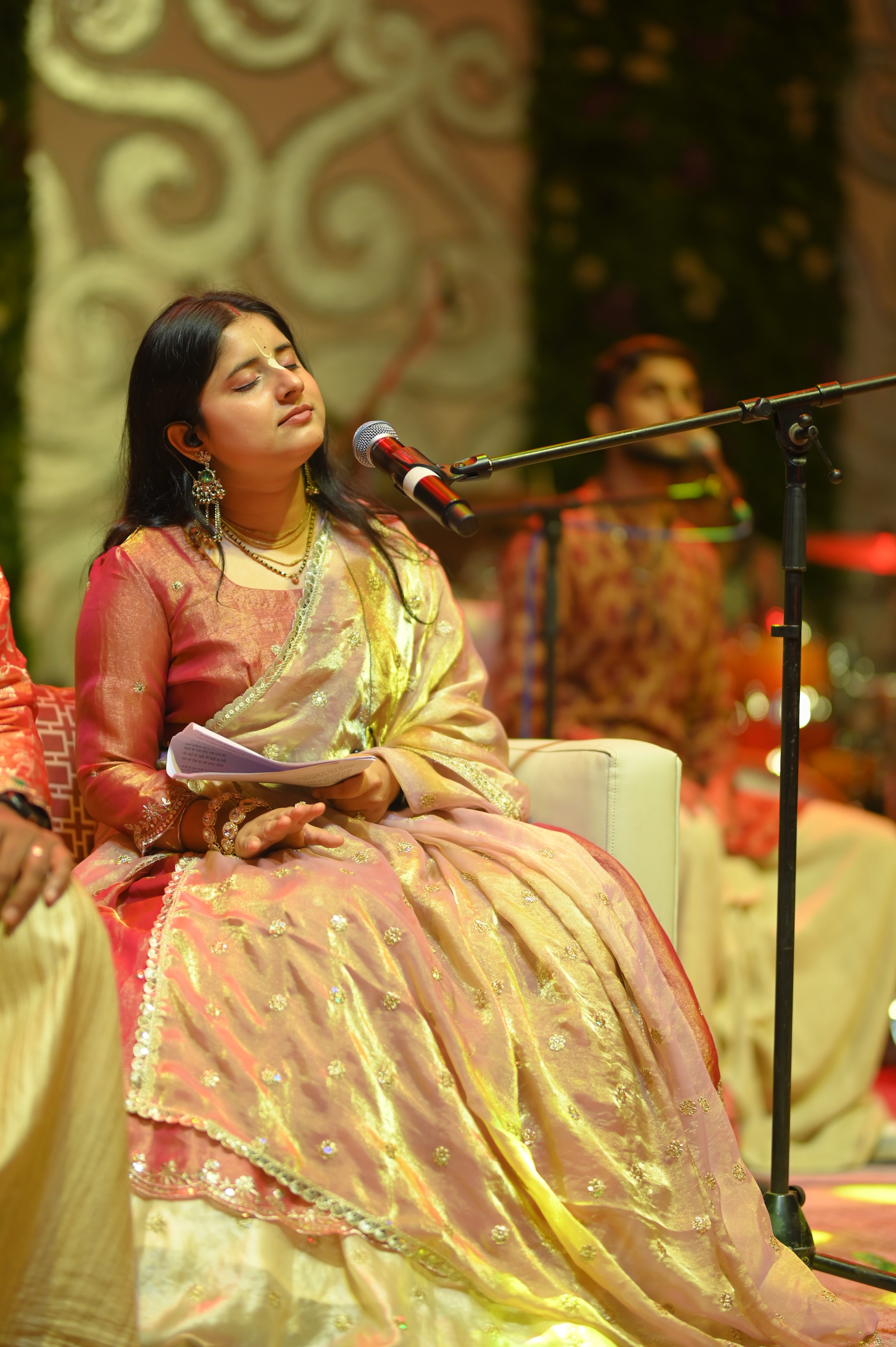 Performer under spotlight on dark stage