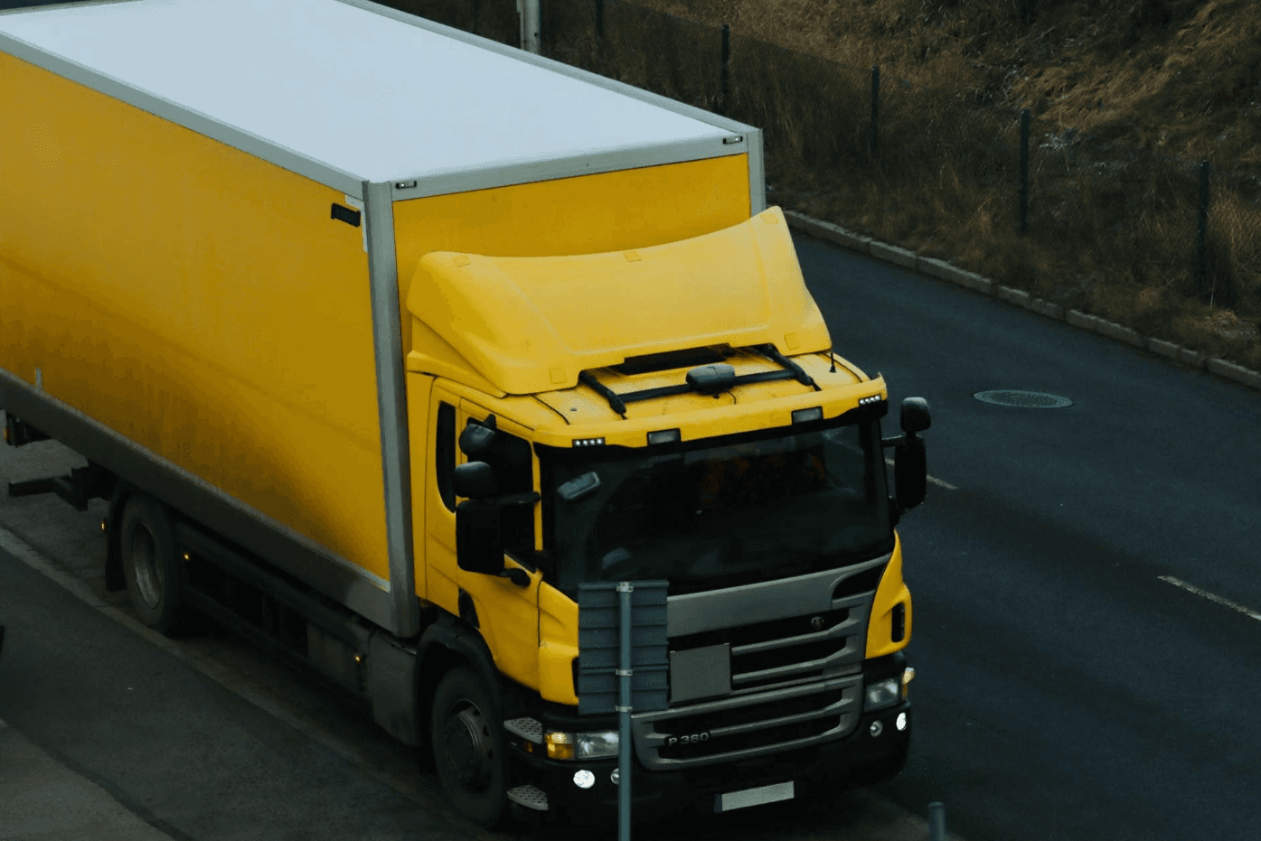 yellow freight truck carrying goods