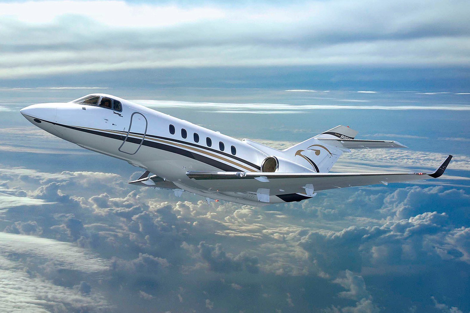 The Hawker 900XP is a mid-size business jet manufactured by Hawker Beechcraft Corporation. It is an upgraded version of the Hawker 850XP with improved avionics, engines, and winglets. The aircraft can seat up to 8 passengers and has a range of 2,904 nautical miles.     The Hawker 900XP is powered by two Honeywell TFE731-50R engines, each producing 4,660 pounds of thrust. It has a maximum cruising speed of 466 knots and can reach a maximum altitude of 41,000 feet. The aircraft has a spacious cabin, measuring 24.4 feet in length, 6 feet in height, and 6 feet in width, and is equipped with modern amenities including an entertainment system, a galley, and a lavatory.     The cockpit features a modern avionics suite, including a Collins Pro Line 21 flight deck, dual flight management systems, and an integrated flight information system. The aircraft also includes a digital autopilot and weather radar, allowing for safer and more efficient flights.      The Hawker 900XP is a popular choice for private and business aviation, offering a balance of performance, comfort, and efficiency.