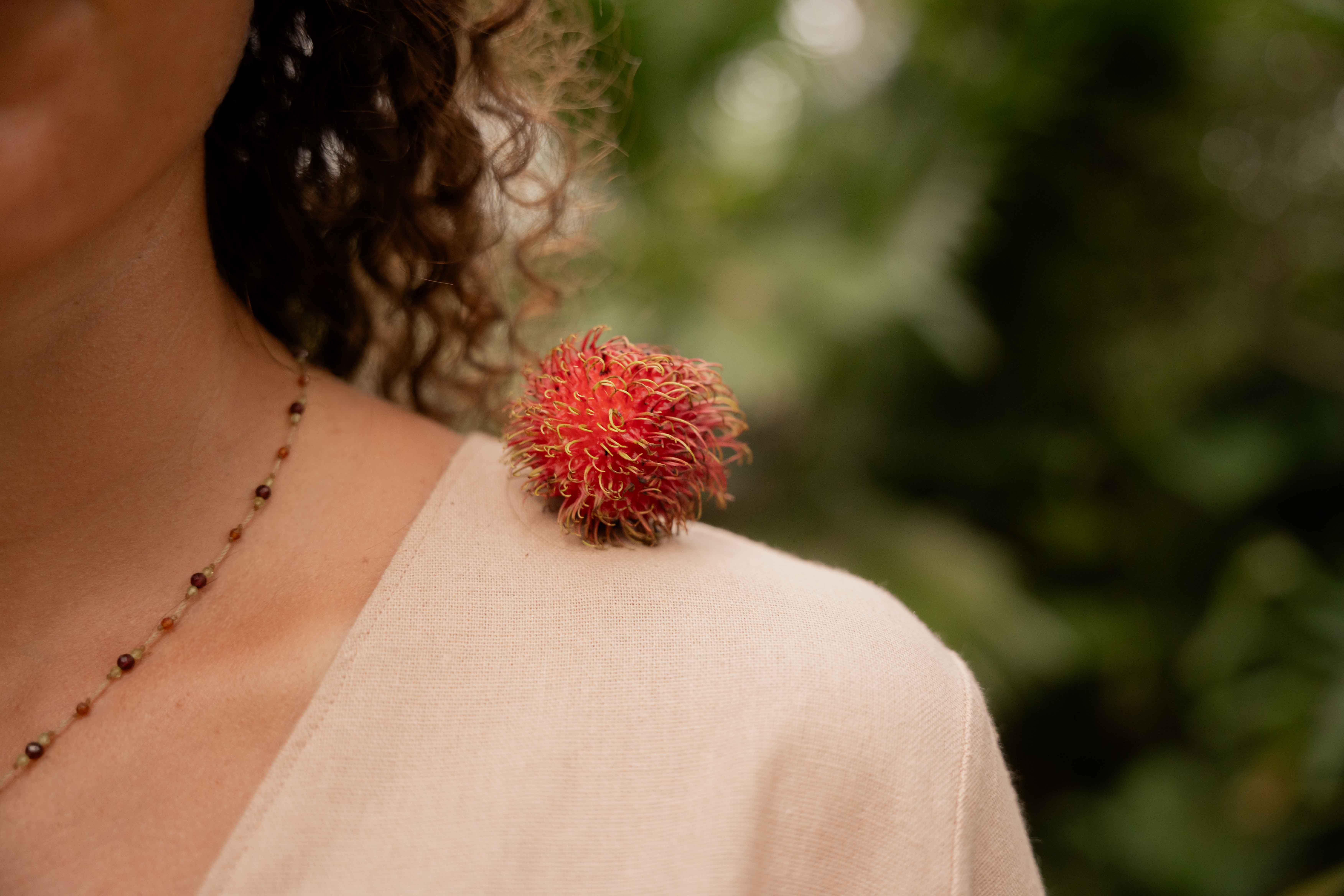 Rambutan fruit on girls shoulder