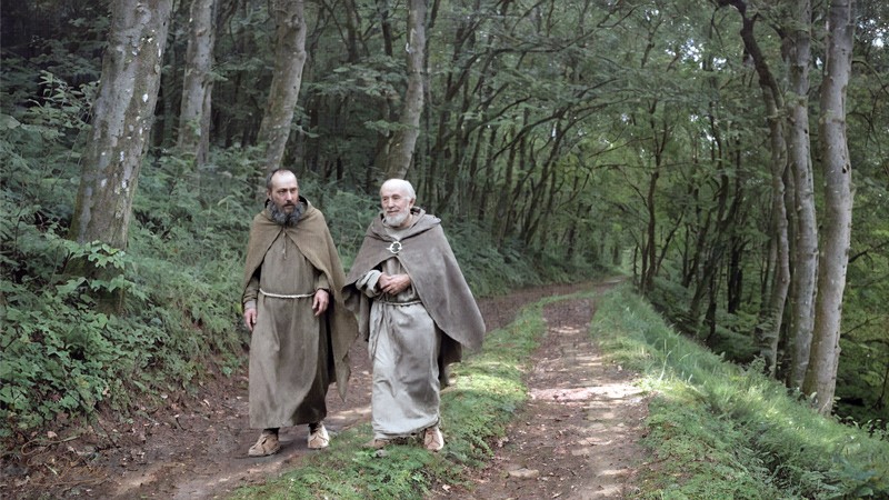 Sacred artwork by Faith and Verse. © Faith and Verse, 2026. All rights reserved. Saint Columbanus and Saint Deicolus walking on a forest path through the Vosges forest, 610 AD.