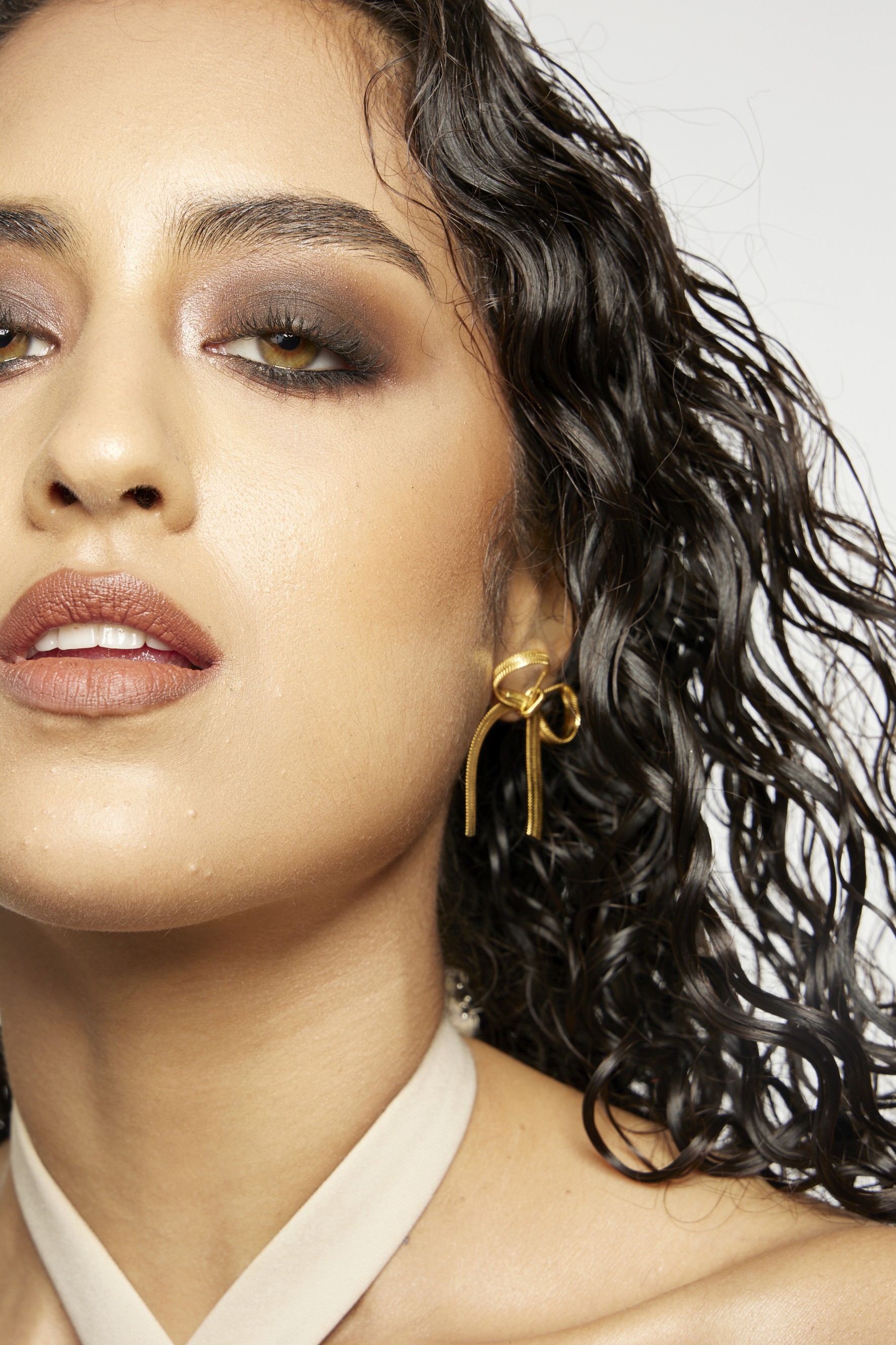 Group of friends smiling on a lively city street at night