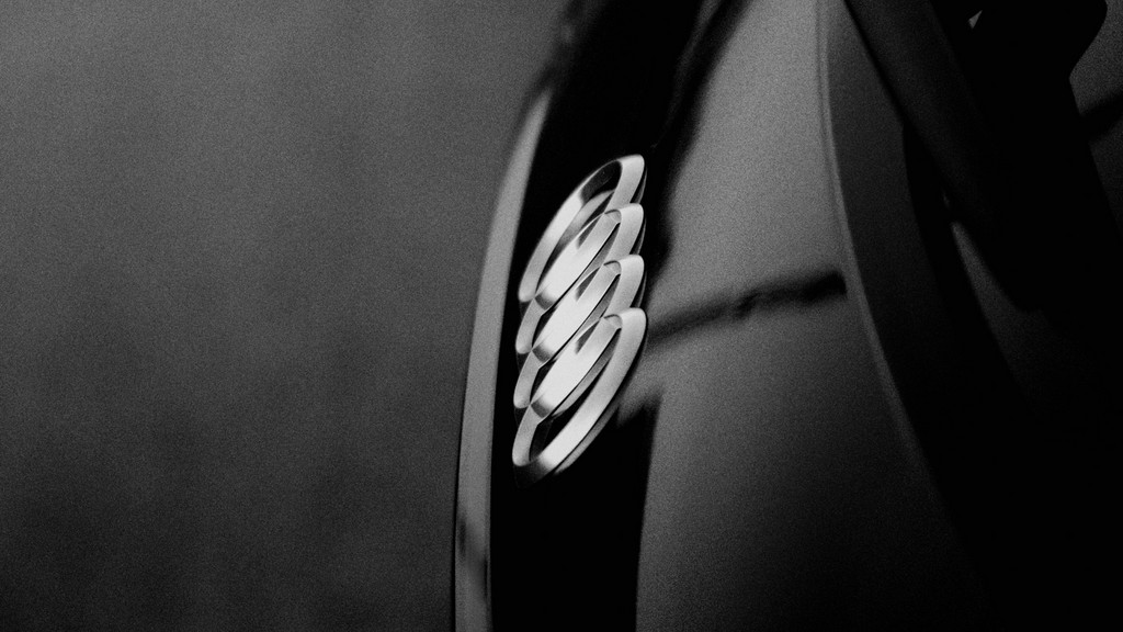 Black-and-white close-up of an Audi emblem