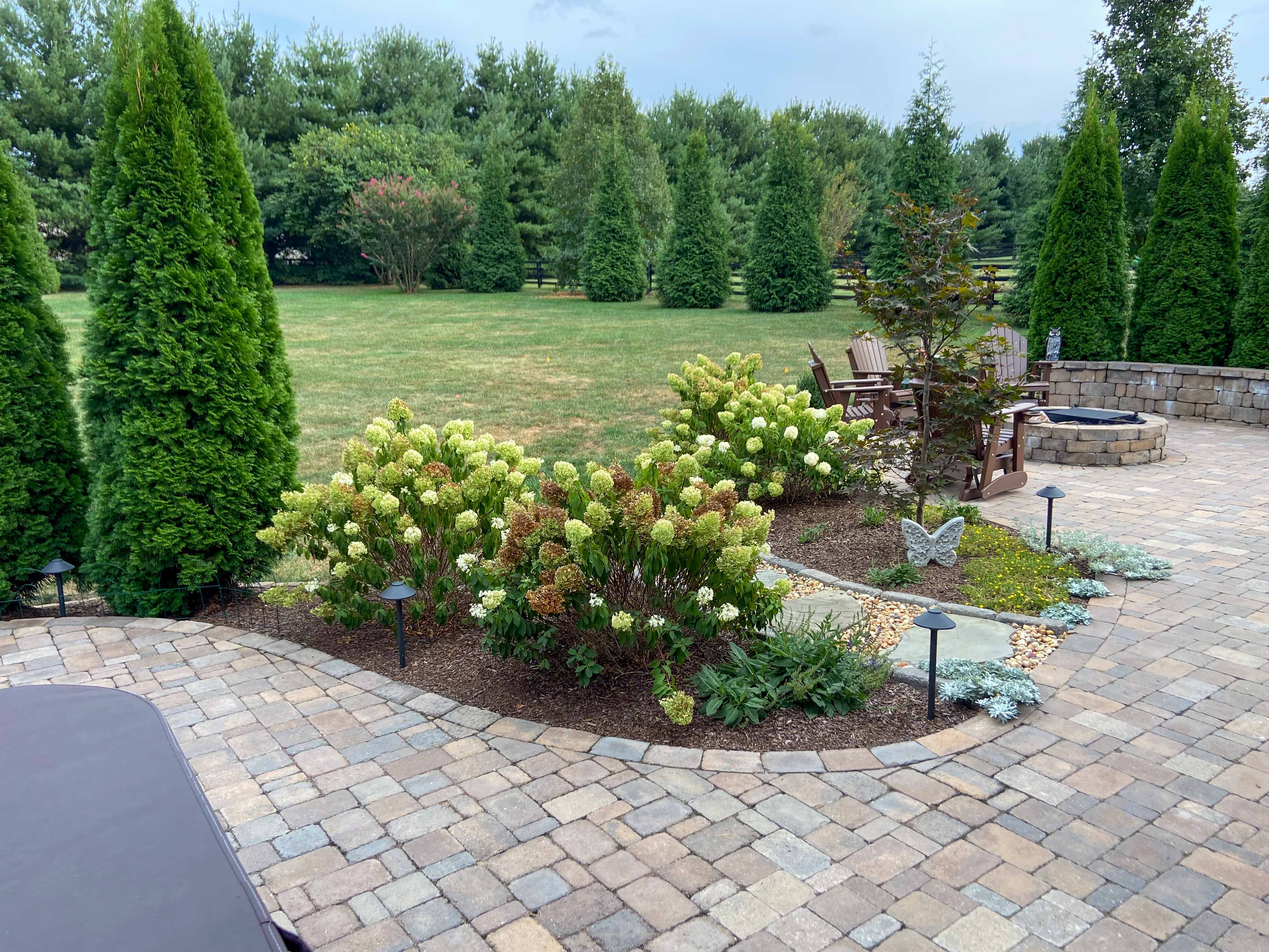 paver patio surrounded by muld and sod installation