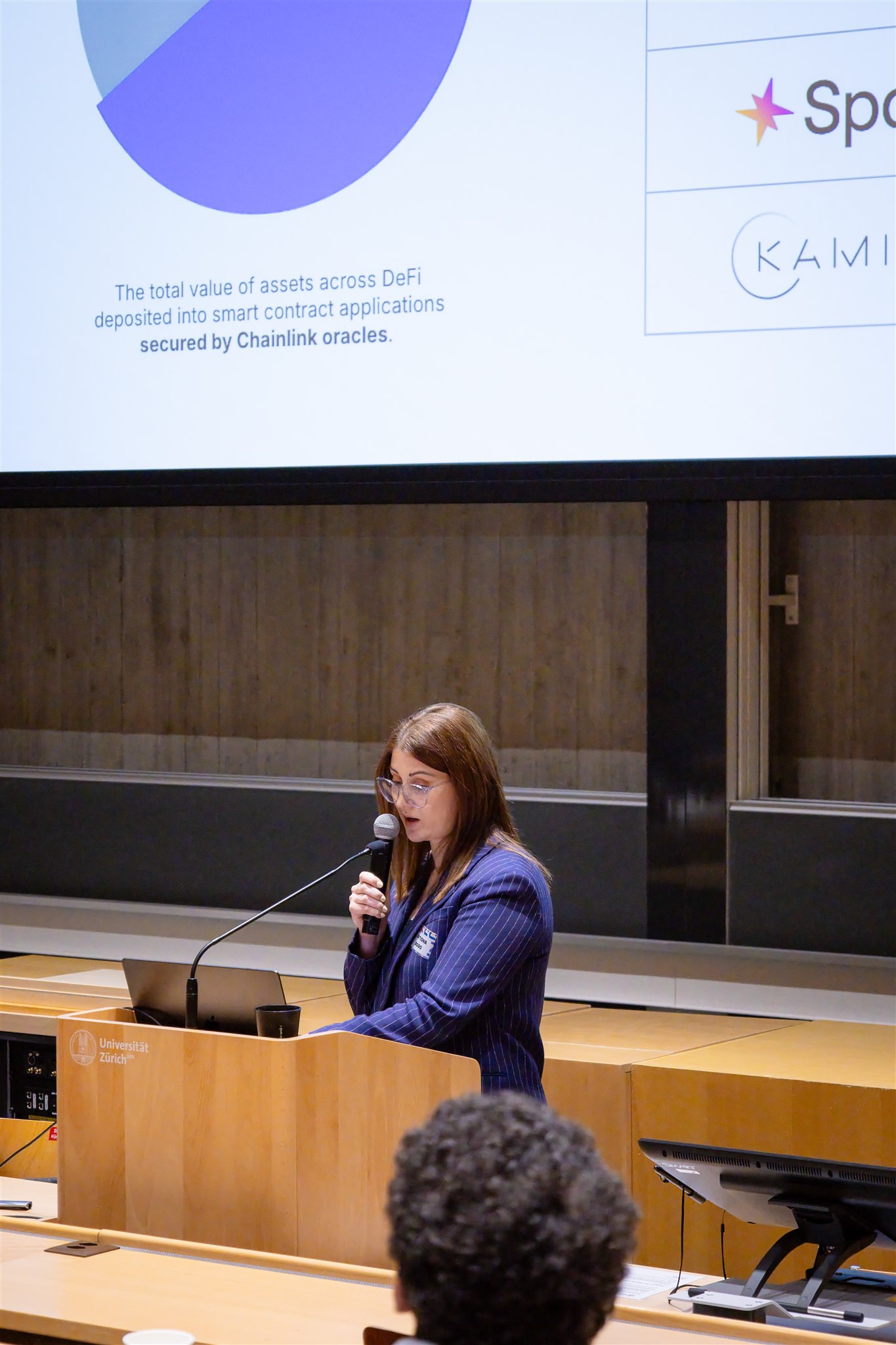 Conference speaker at podium during EthereumZüri session at University of Zurich
