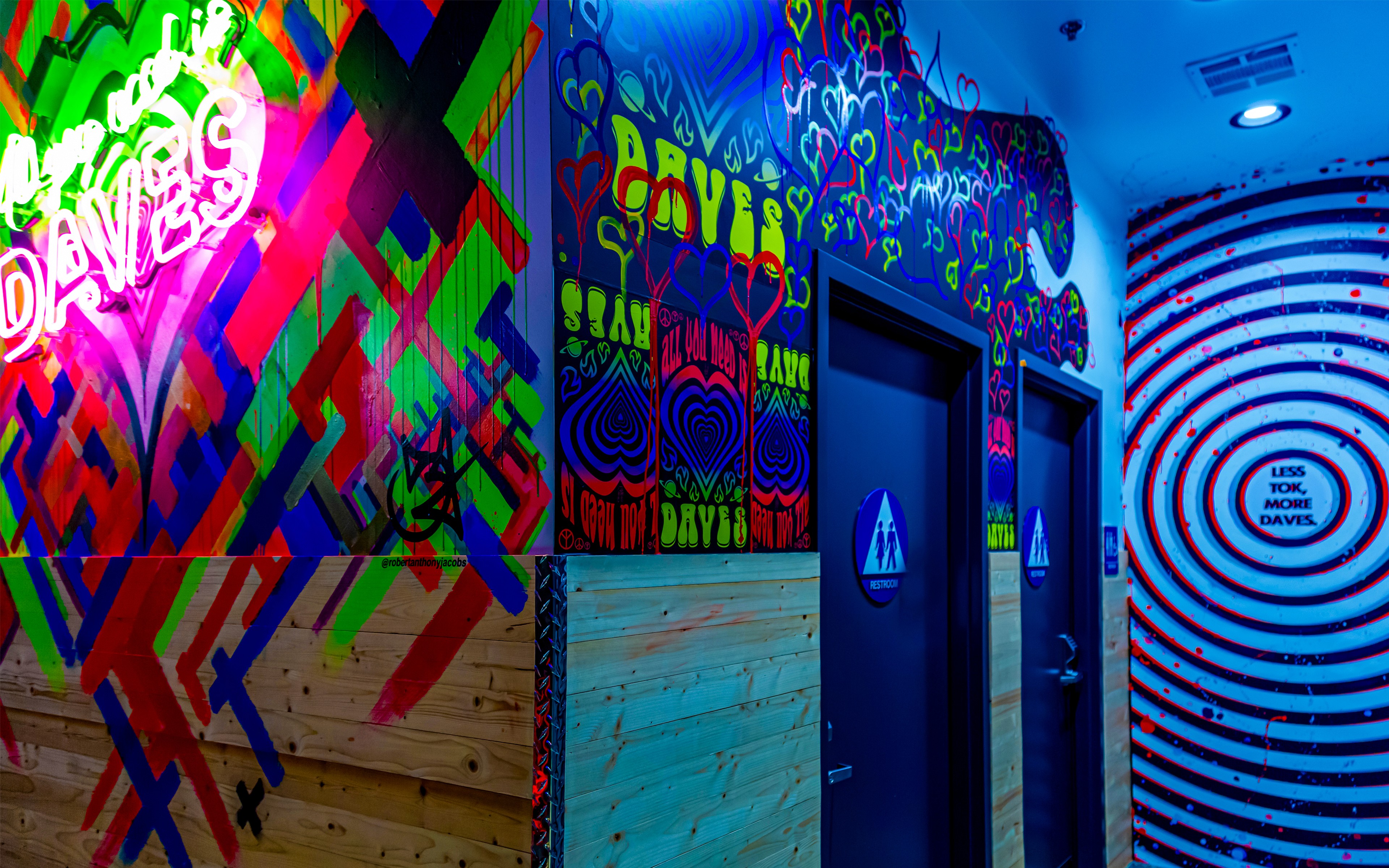 Interior mural installation at Dave’s Hot Chicken Port Hueneme featuring colorful graffiti walls and optical target design.
