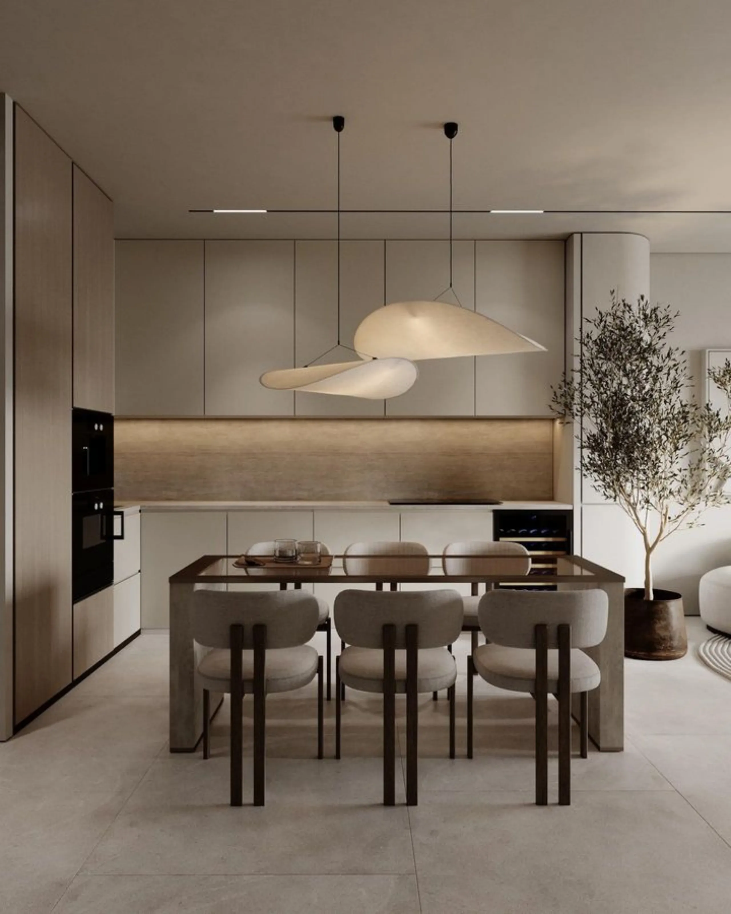 Minimalist kitchen with beige cabinetry, sleek countertops, and modern pendant lights. A dining table with six chairs and a potted tree add elegance.