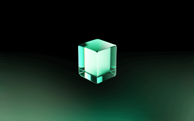 A green glass cube in a gradient background