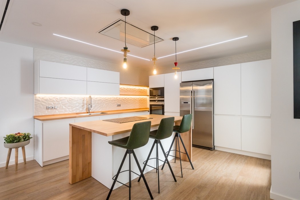 Double-height interior with flowing sculptural forms and warm raking light