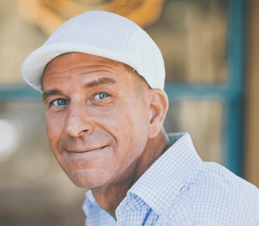 man smiling while sitting