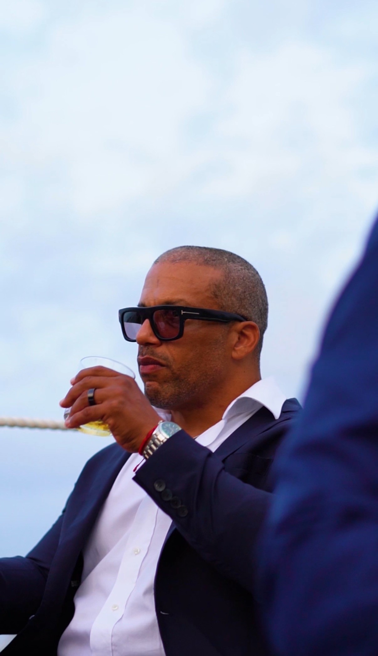 woman in black long sleeve shirt wearing white hat standing on green grass field during daytime