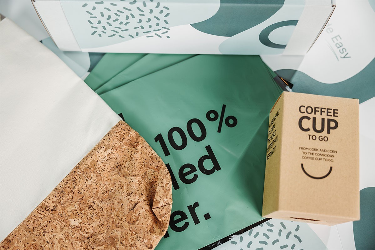 Eco-friendly packaging with a green sheet, cork material, and a cardboard cup box
