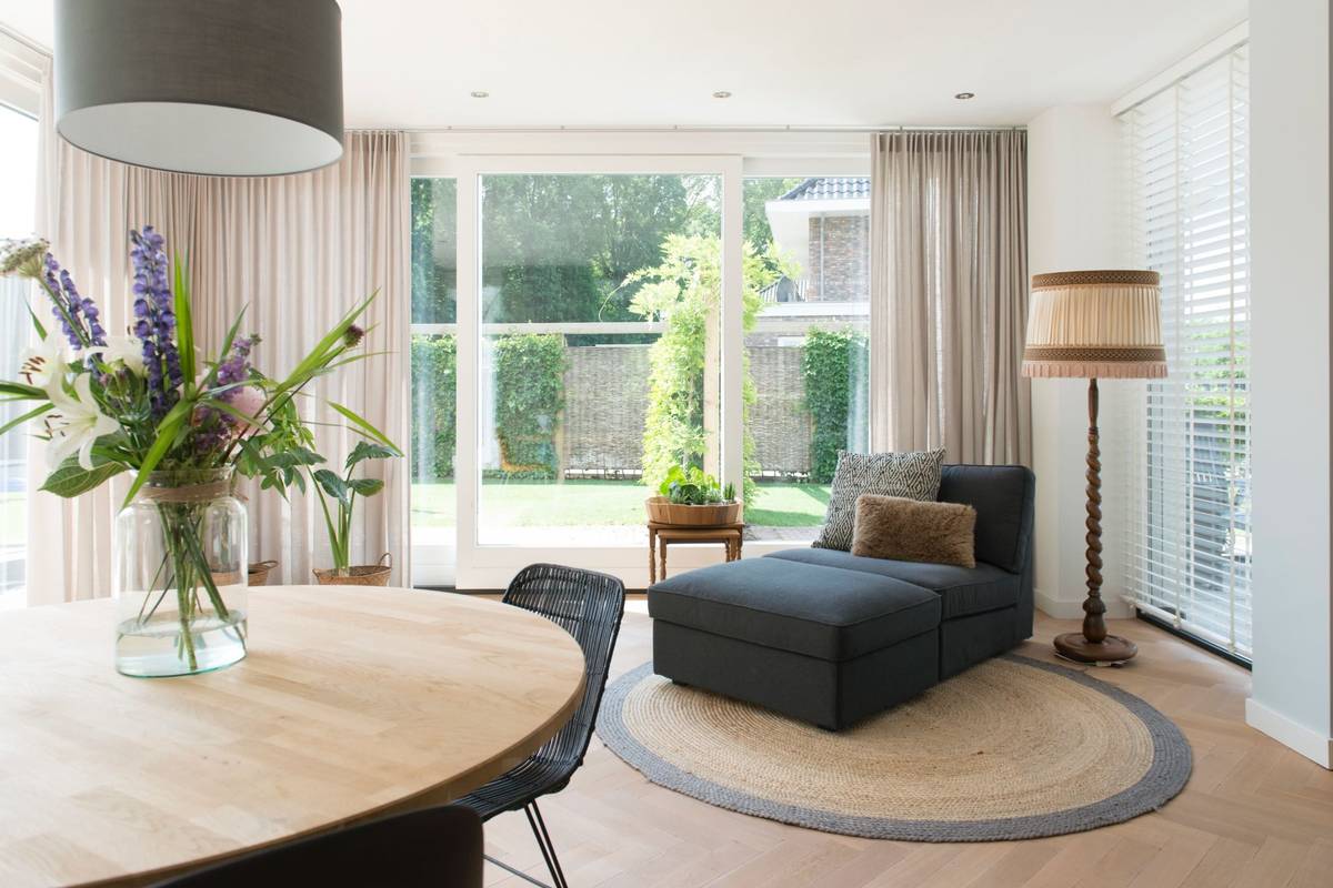 tuinkamer inrichting, chaise longue en ronde eettafel neutrale stijl