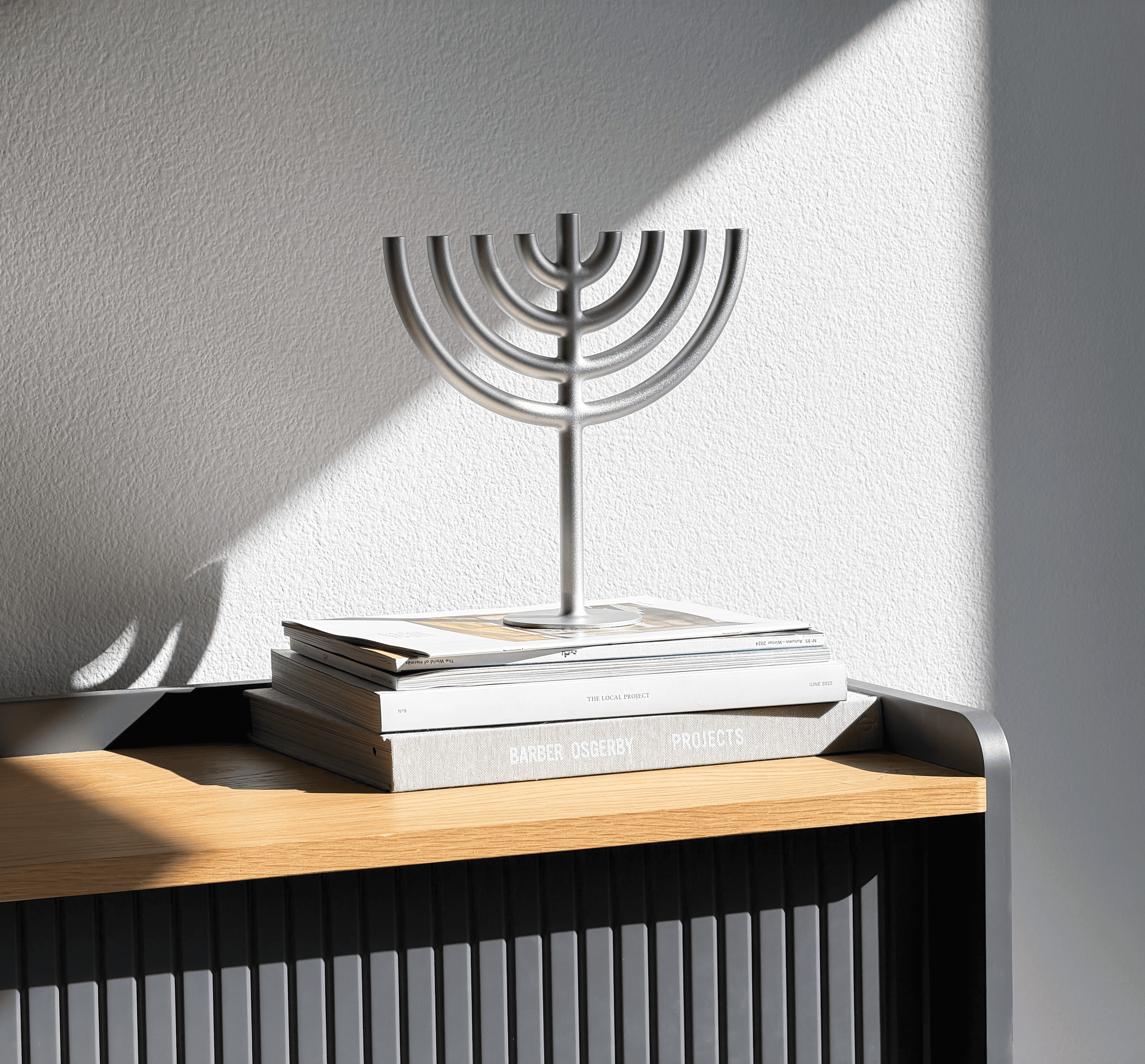 Streetside billboard with flyposters of the Batch.Works brand and illustrations