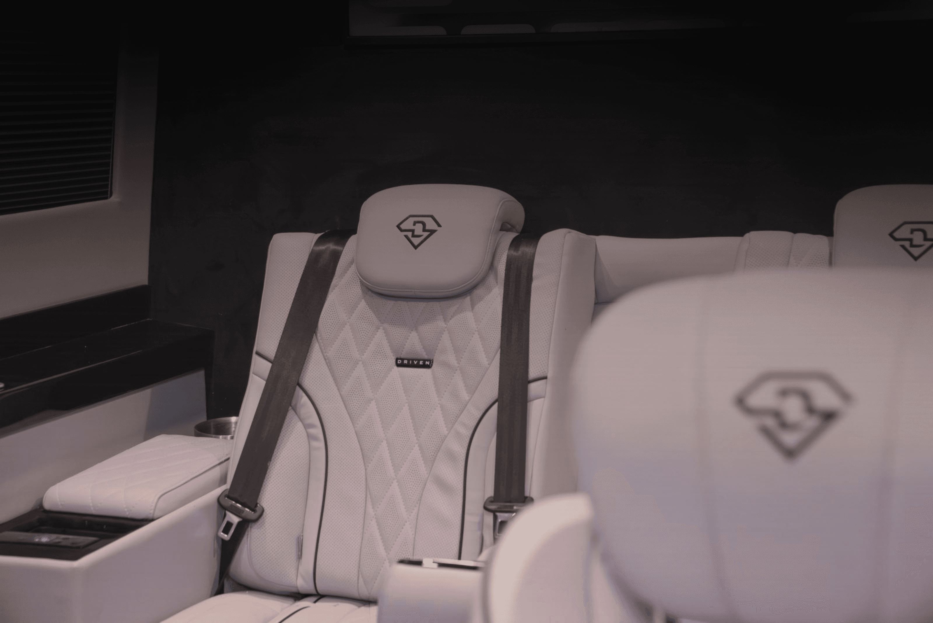 Two cheerful men laughing in the front seats of a sportscar, great for car rental joy promotions.