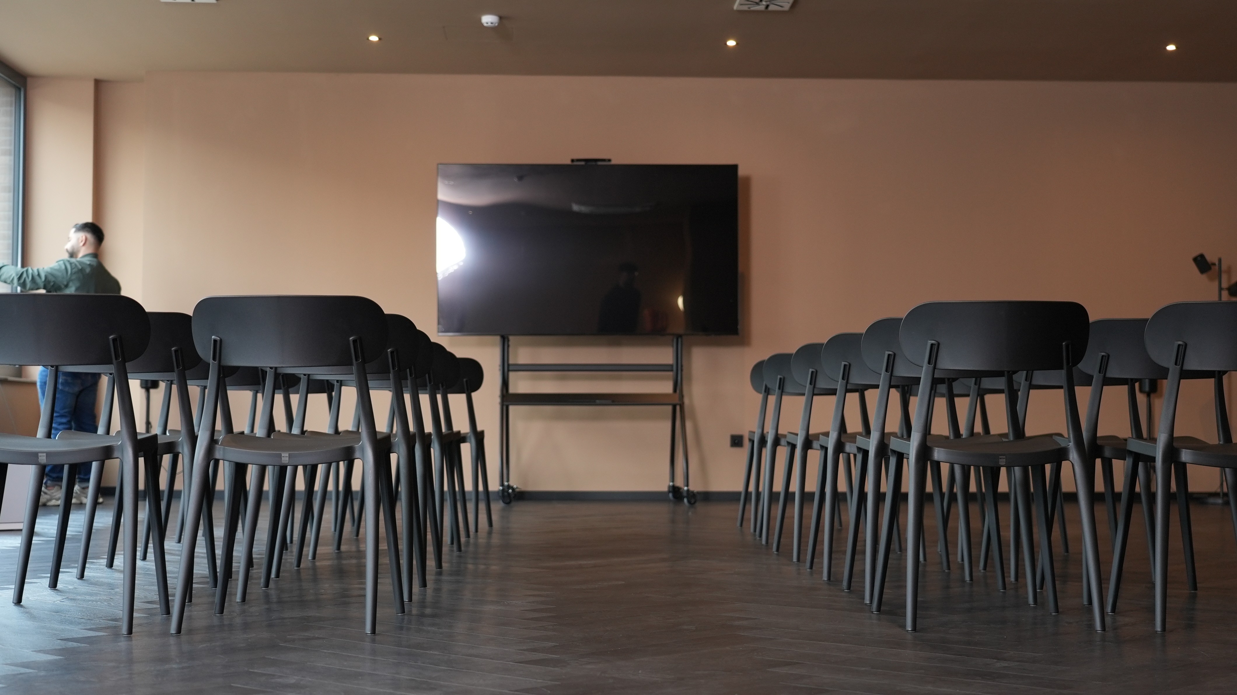 Athletes resting on a blue running track.