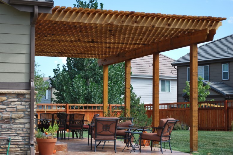 amazing and beautiful wood patio cover in Colorado with wooden slats has been cut to create unique shapes