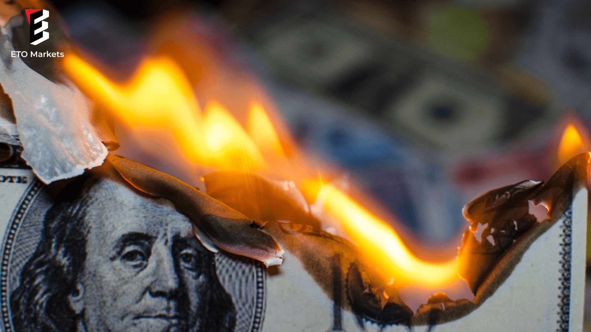 A hundred dollar bill in American US currency is on fire
