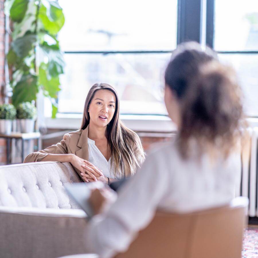 woman meeting with therapist one on one