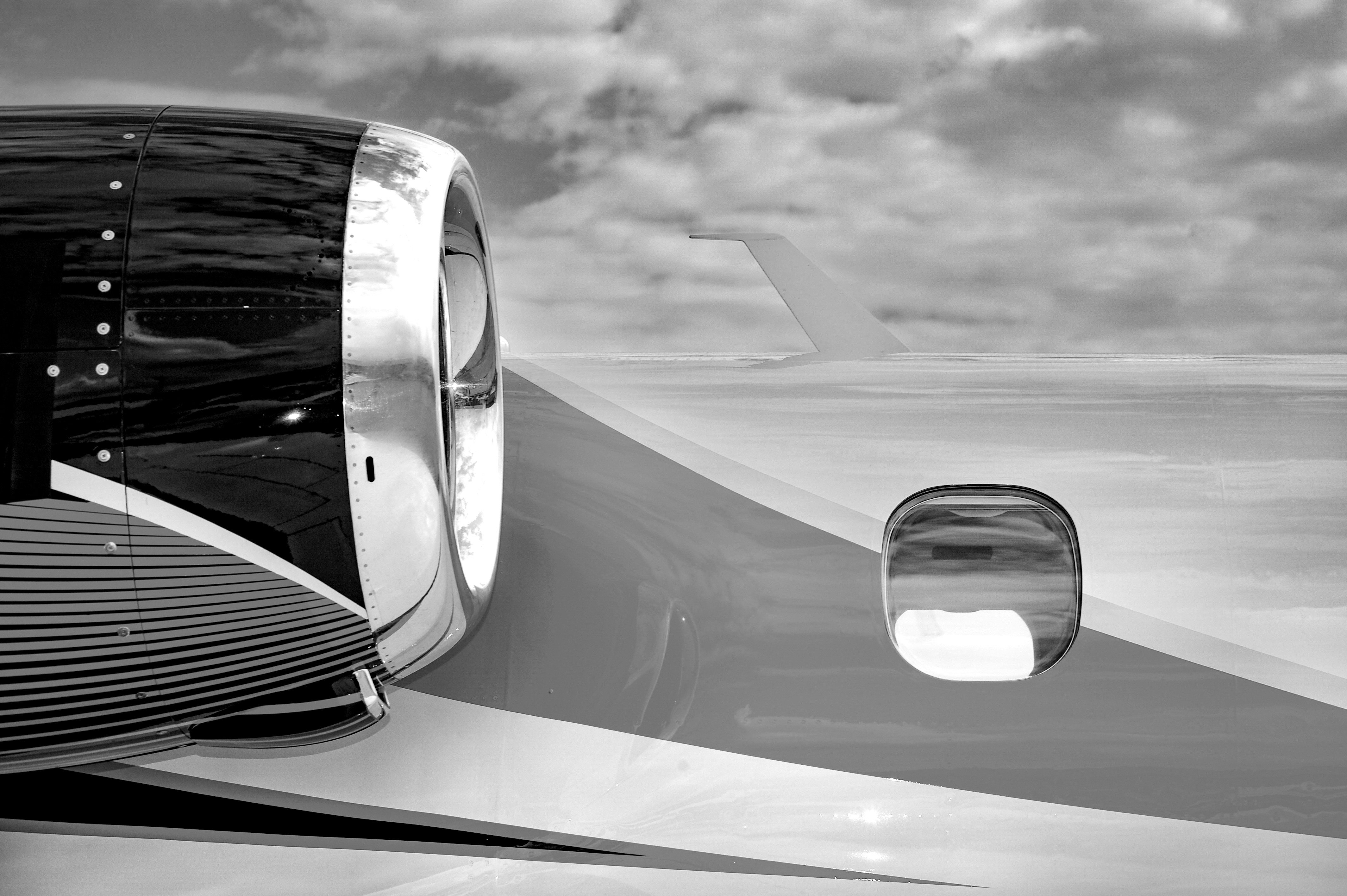 Close-up of a hair dryer nozzle with a black circular vent, against a textured background.