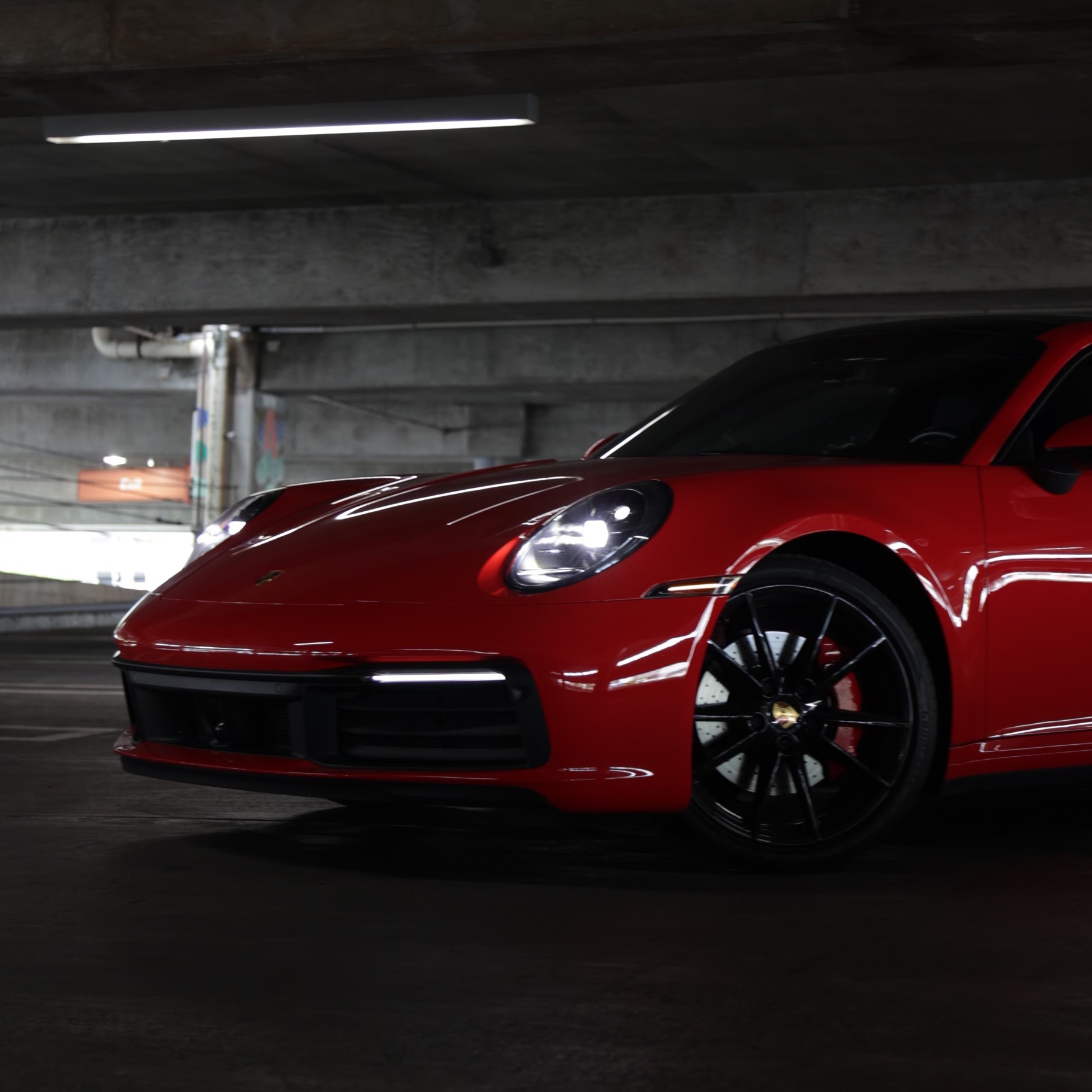 Exotic silver Porsche 911 Carrera S with its iconic rear-engine design, parked in a scenic Miami backdrop – a top choice for Porsche rental Miami.