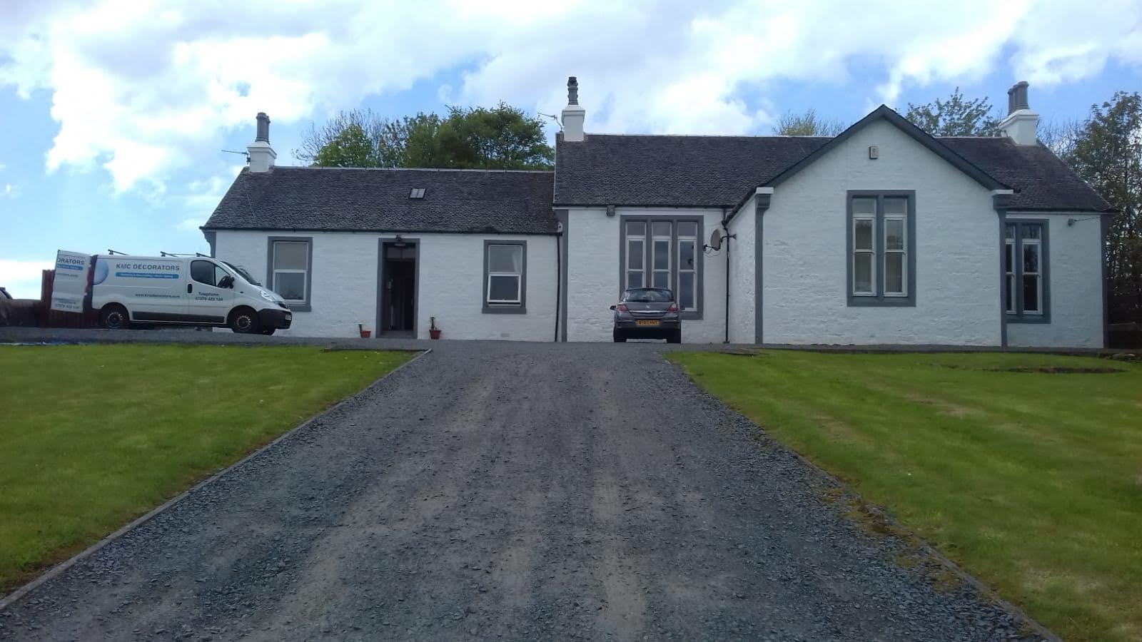 A bungalow with a stone road leading up to the front of the house