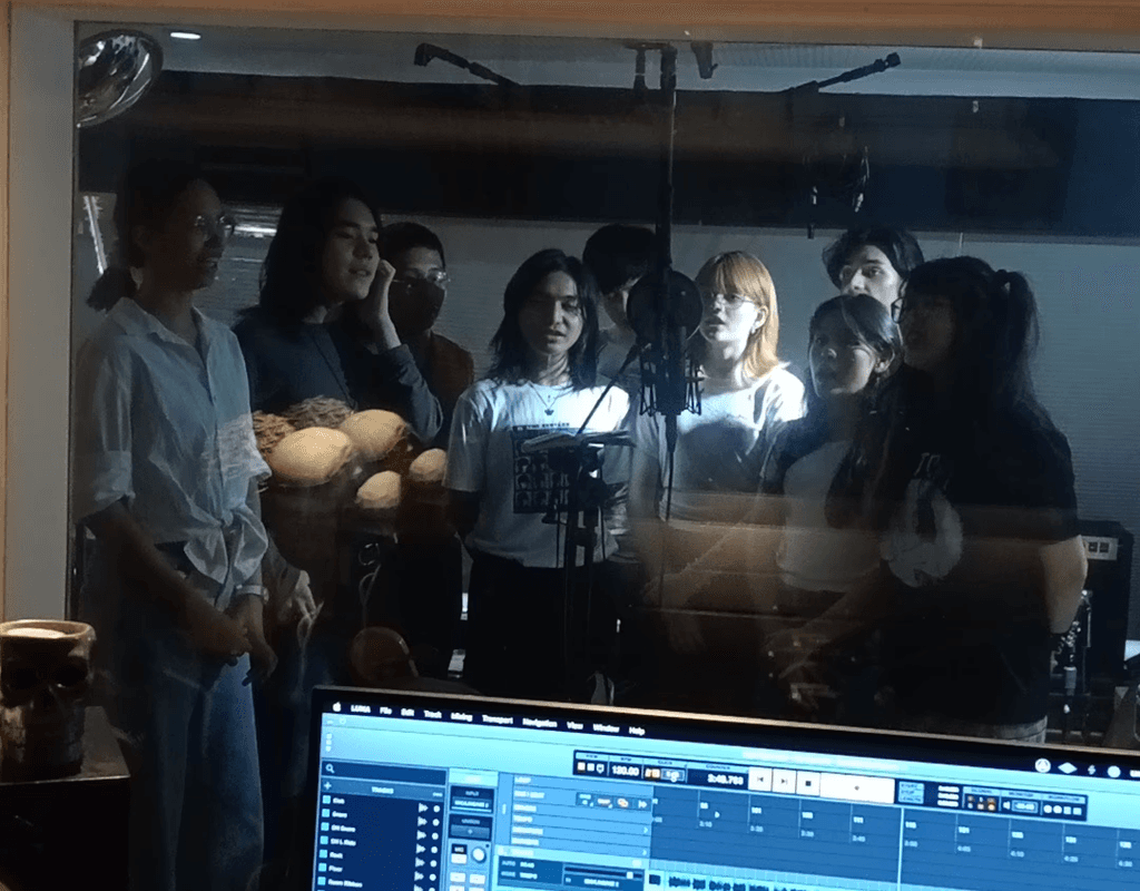 A photo of Abot Tala members recording background vocals for Ely Buendia's song, "Bulaklak sa Buwan".