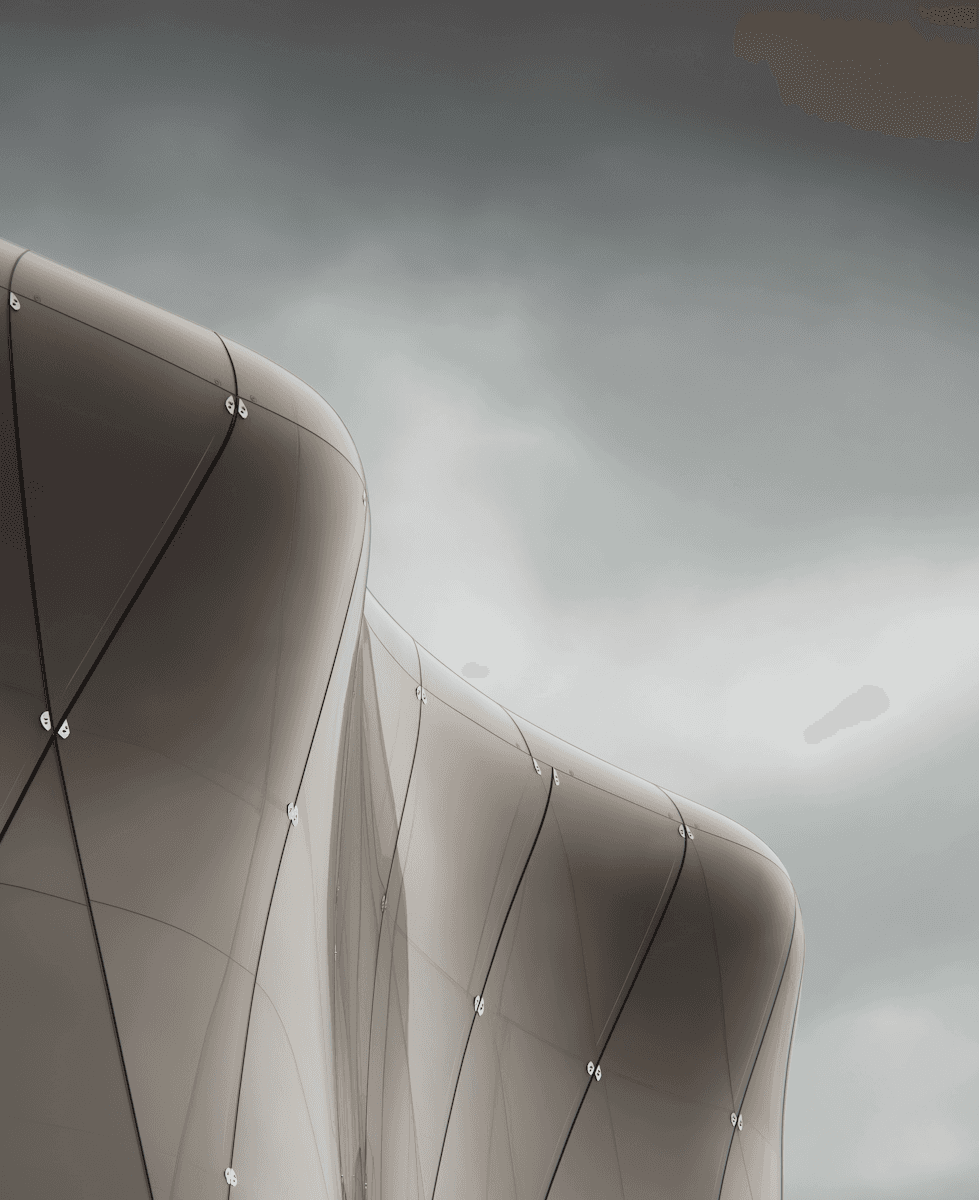 Modern architectural structure with sweeping curves and sharp angles, featuring a sleek white facade and dynamic silhouette.