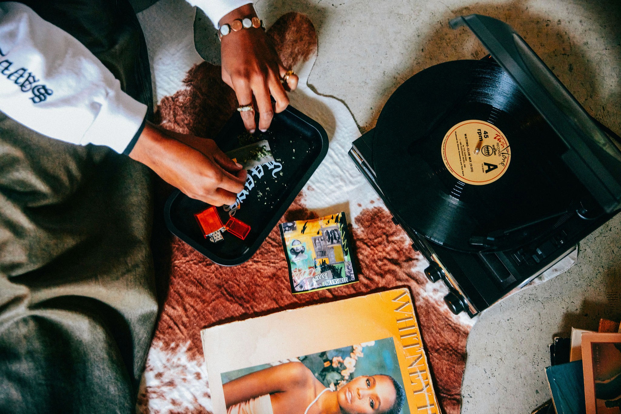 Athletes resting on a blue running track.