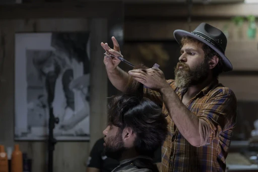 Barber posing with razor and scissor