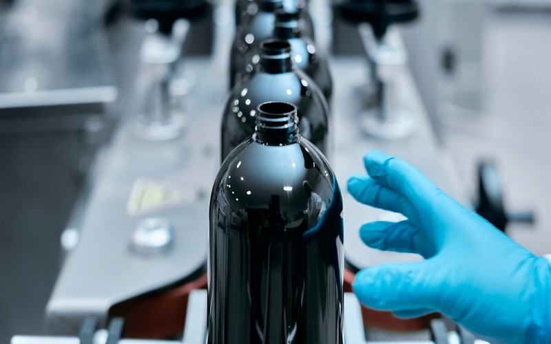Brown Glass Bottle with Hand reaching