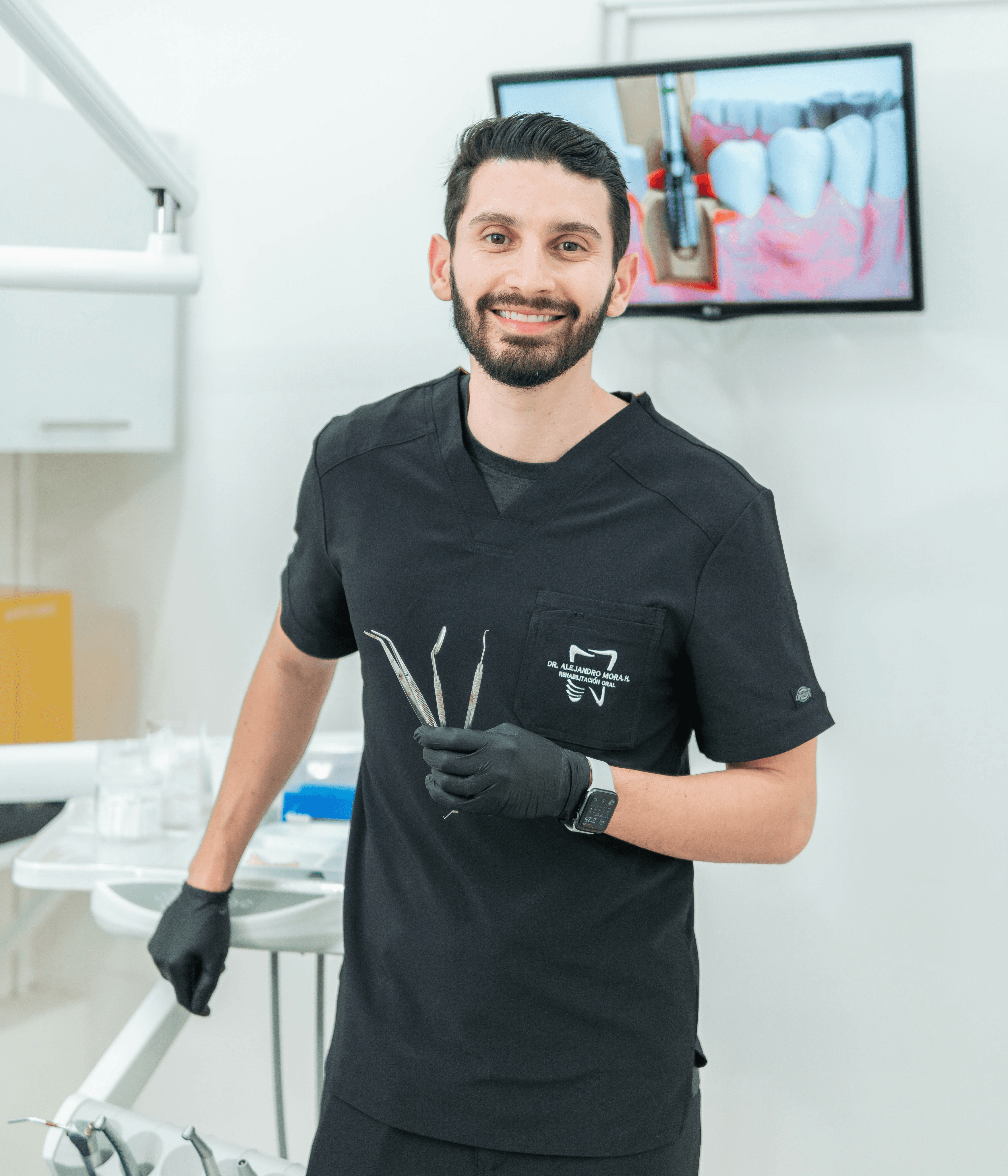 a man in a dentist's office holding a pair of scissors