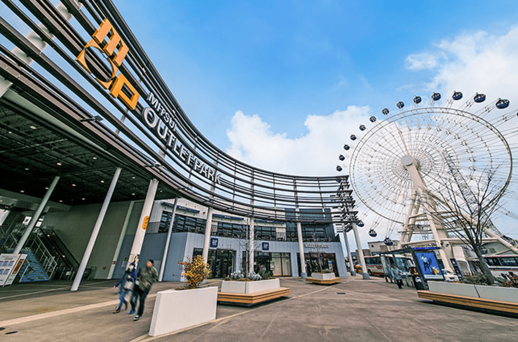 A modern mall with a ferris wheel in the background