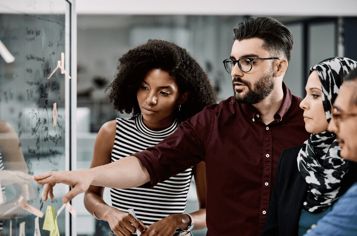 A group of young professionals working together, likely engaged in a team collaboration or discussion