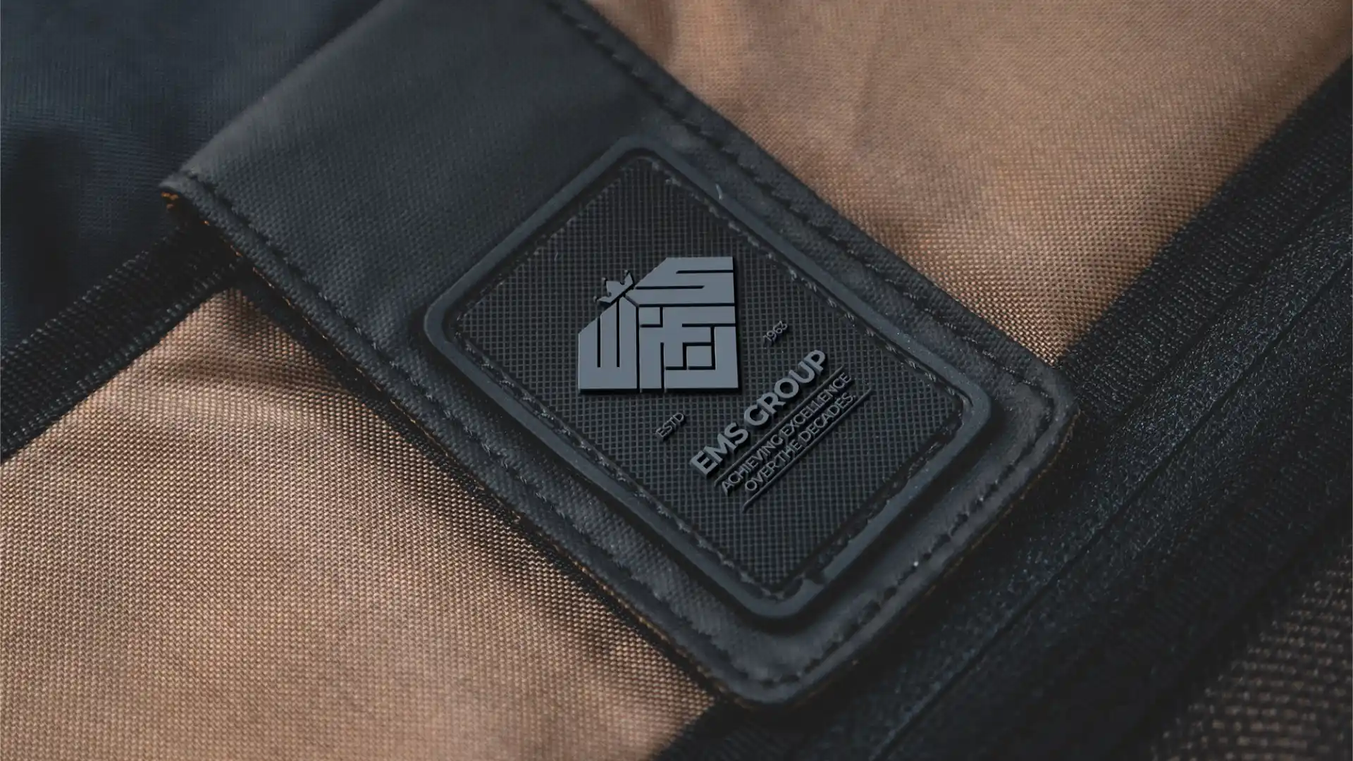 EMS Group rubber patch logo label on branded fabric carry bag