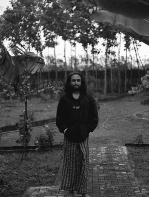 A man playing a drum in front of a group of people