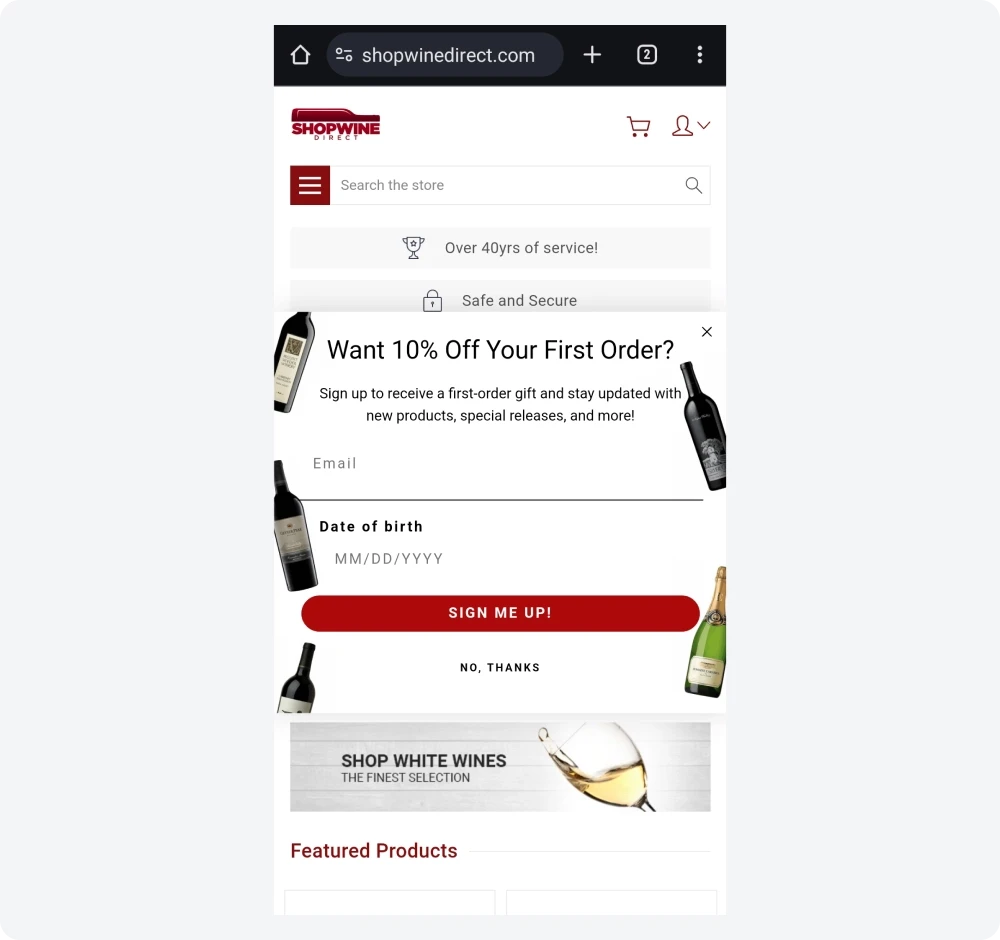 Shopwinedirect mobile welcome popup with wine bottle graphics, an explicit 10% discount offer, an email field, and a date of birth selector