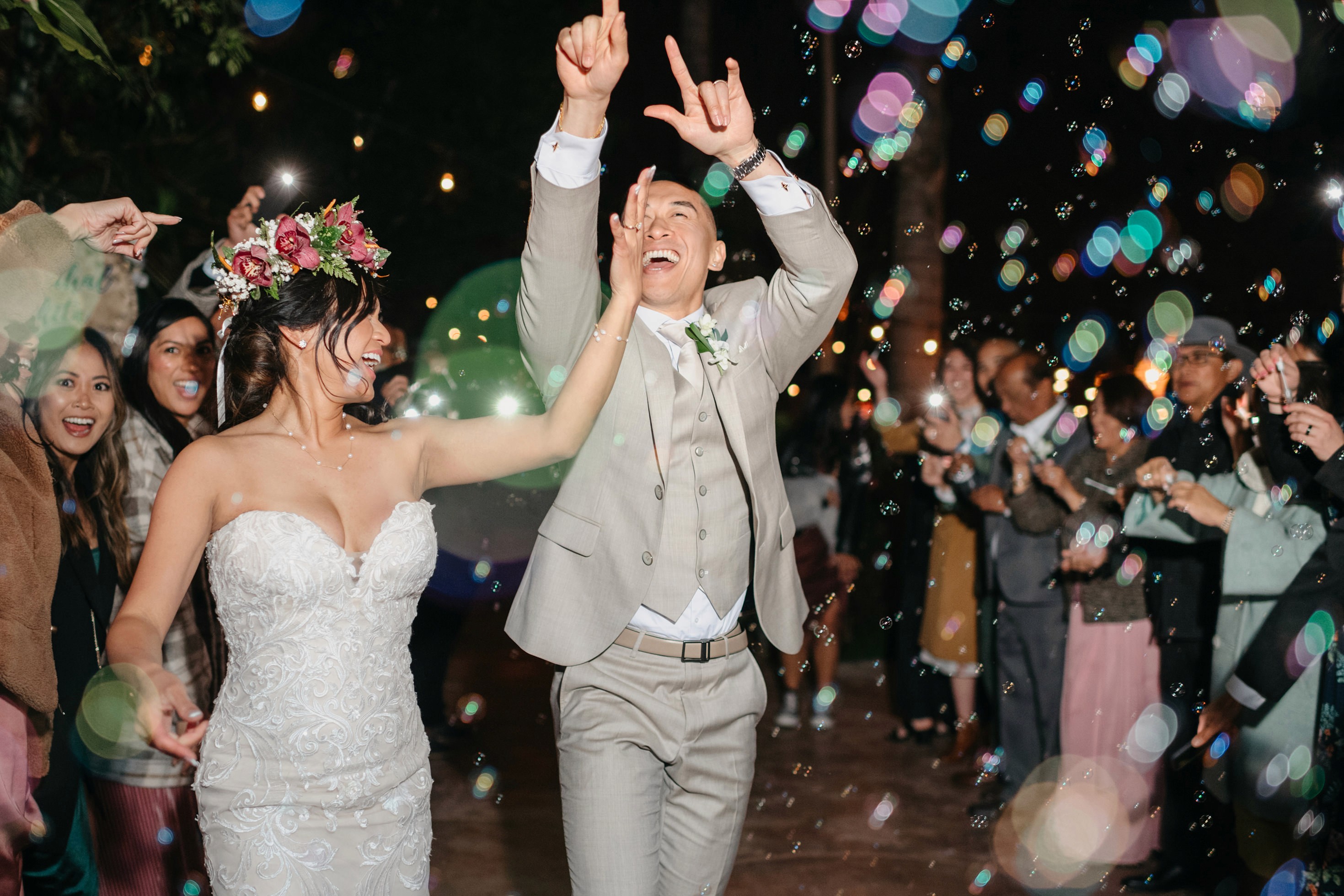 Night portrait of bride and groom grand exit with bubbles in the background