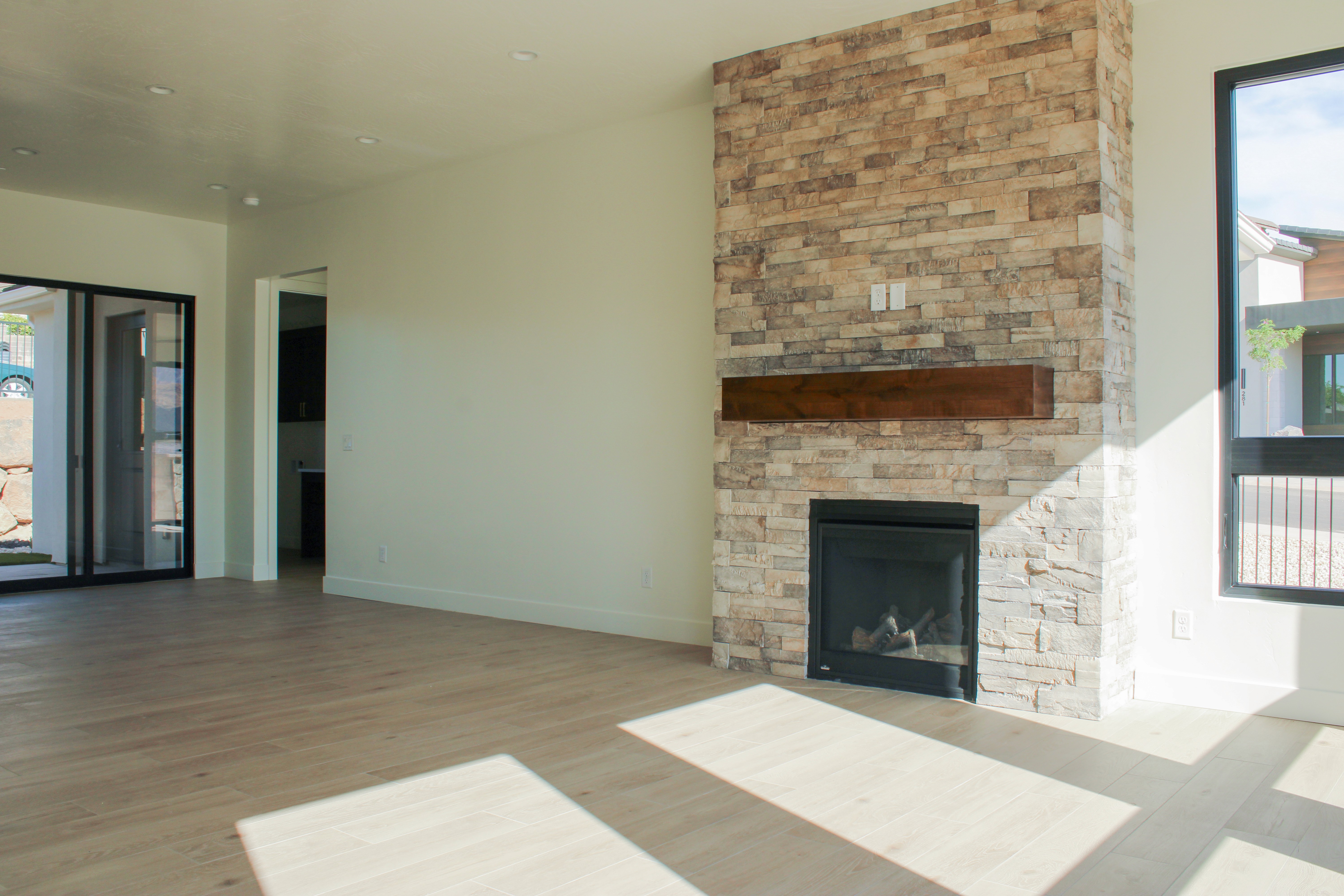 Living room fireplace detail at The Overlook at Falcon Ridge in Hurricane, Utah, showcasing textured stonework and built-in hearth design.