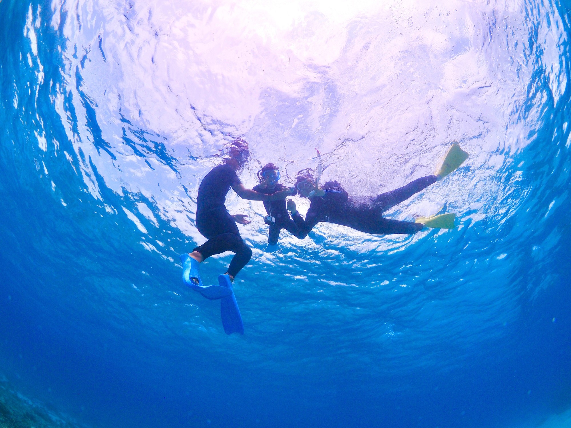 2 person riding on red kayak on body of water during daytime